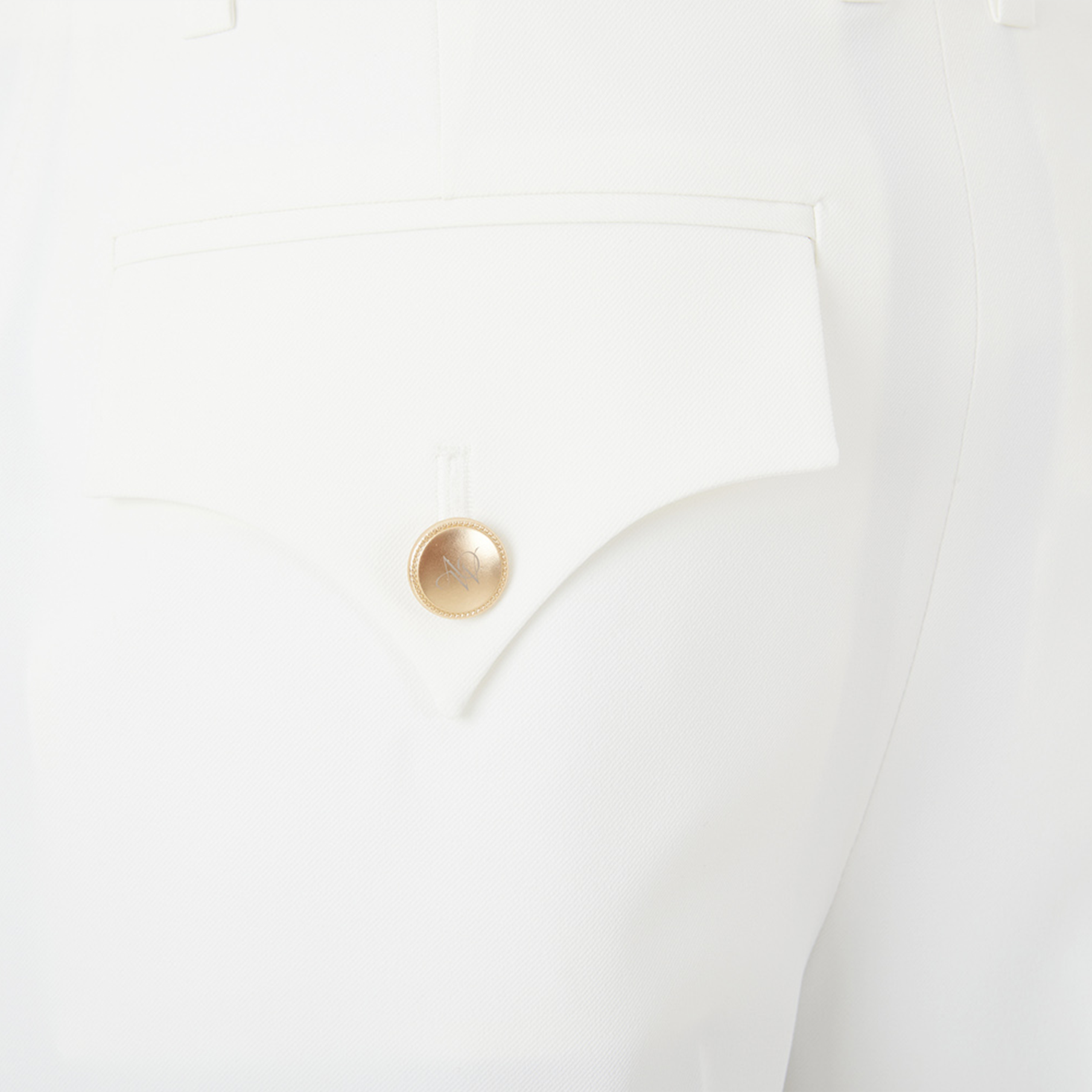 Gold button on a white short pocket
