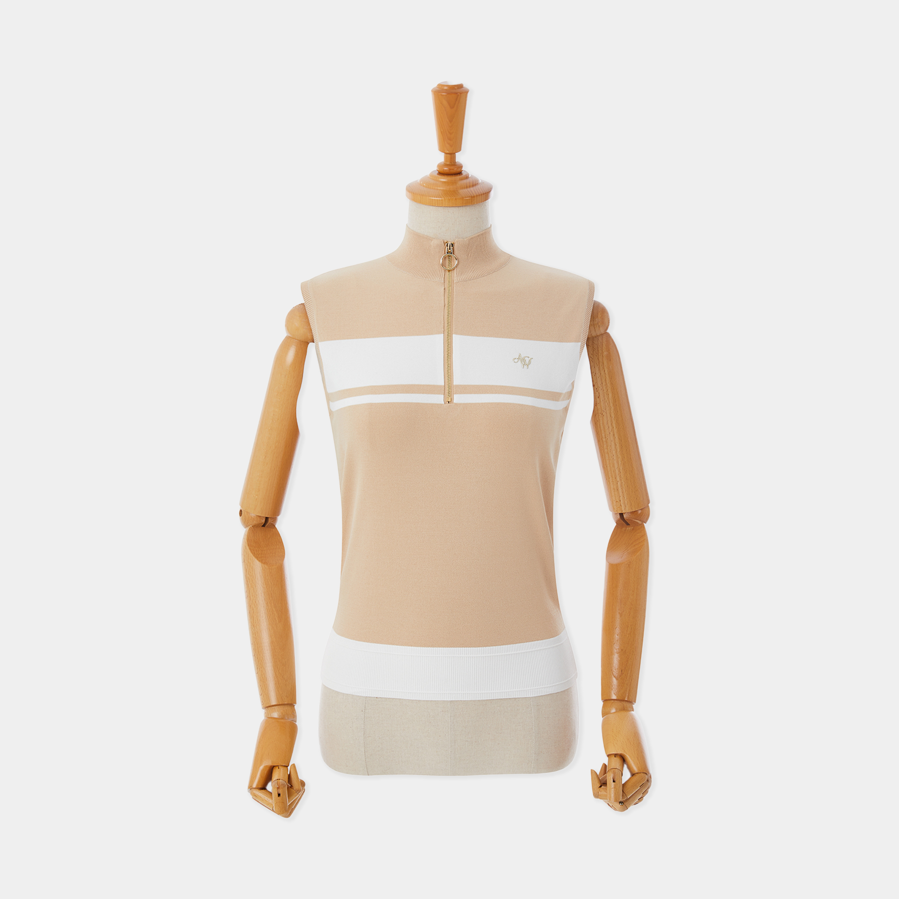Mannequin wearing a beige and white top on a white background