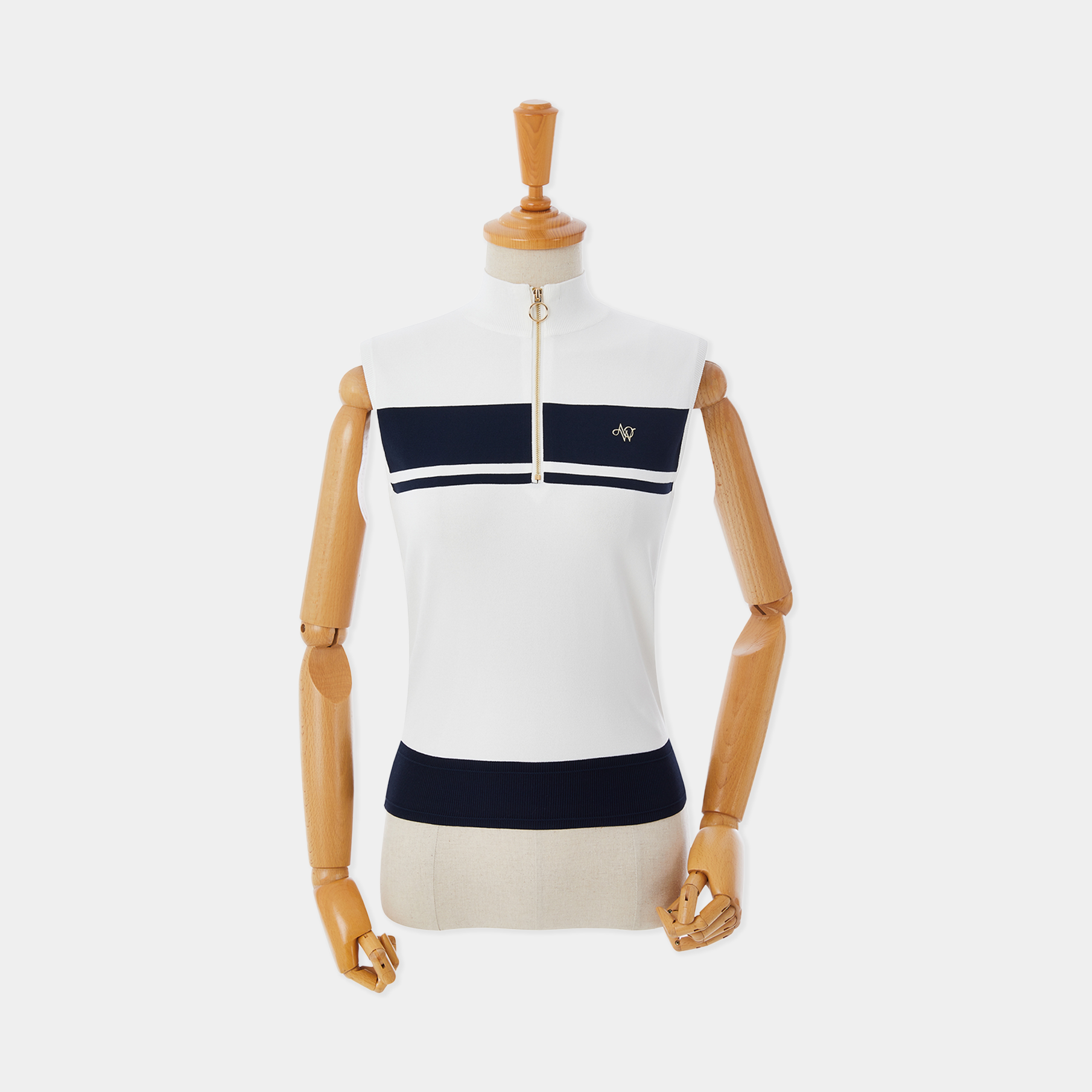 White sleeveless top with navy accents on a mannequin against a white background