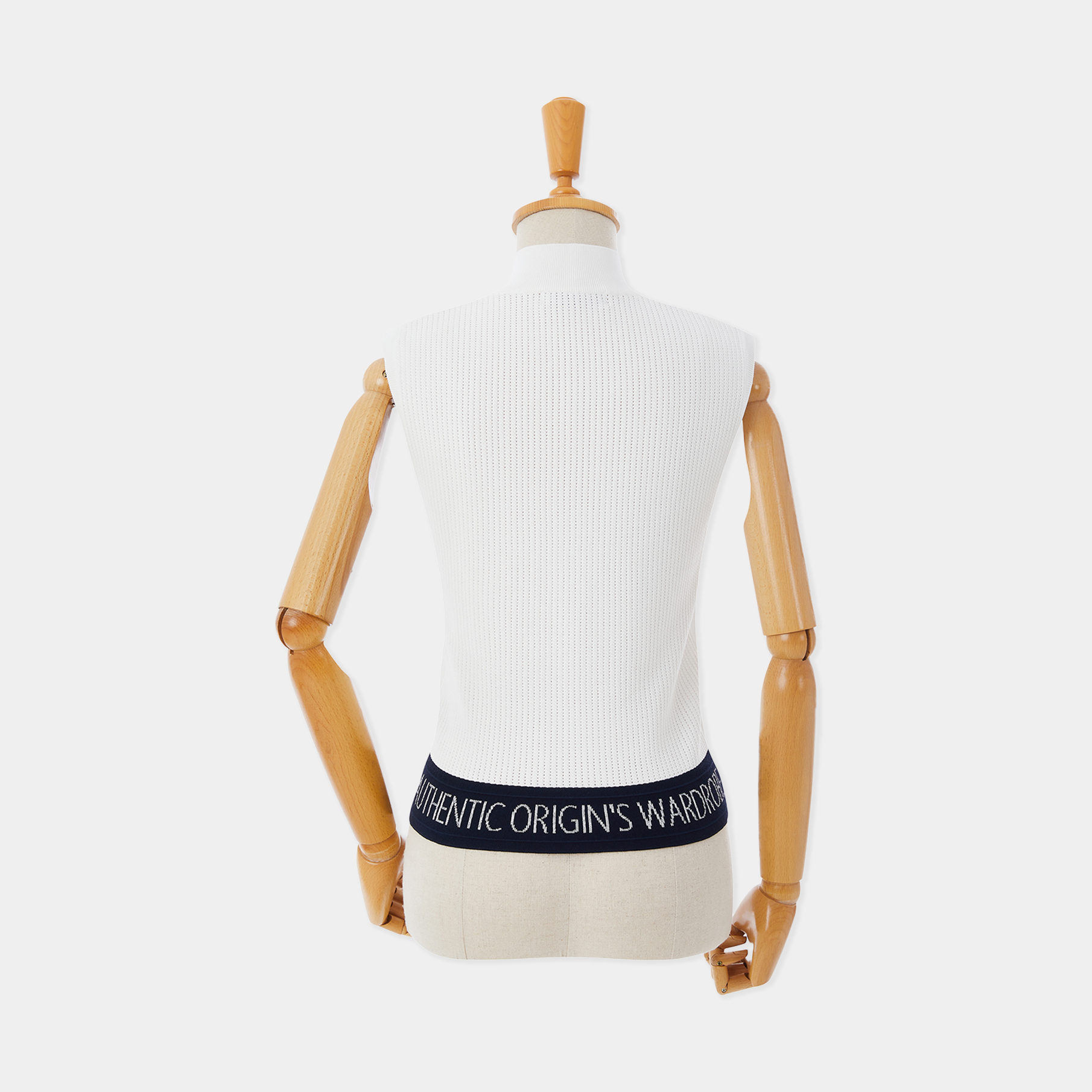 Mannequin wearing a white ribbed sweater with a black waistband displaying 'Authentic Origin's Wardrobe' on a white background.