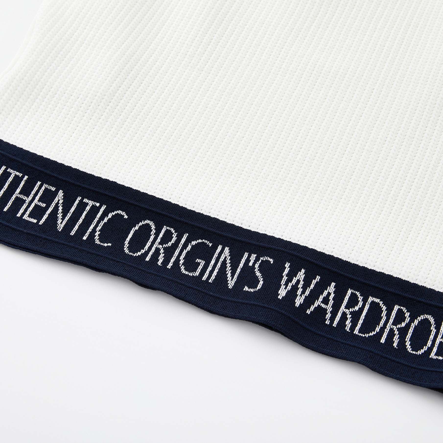 Text on a white shirt with 'Authentic Origins Wardrobe' branding.