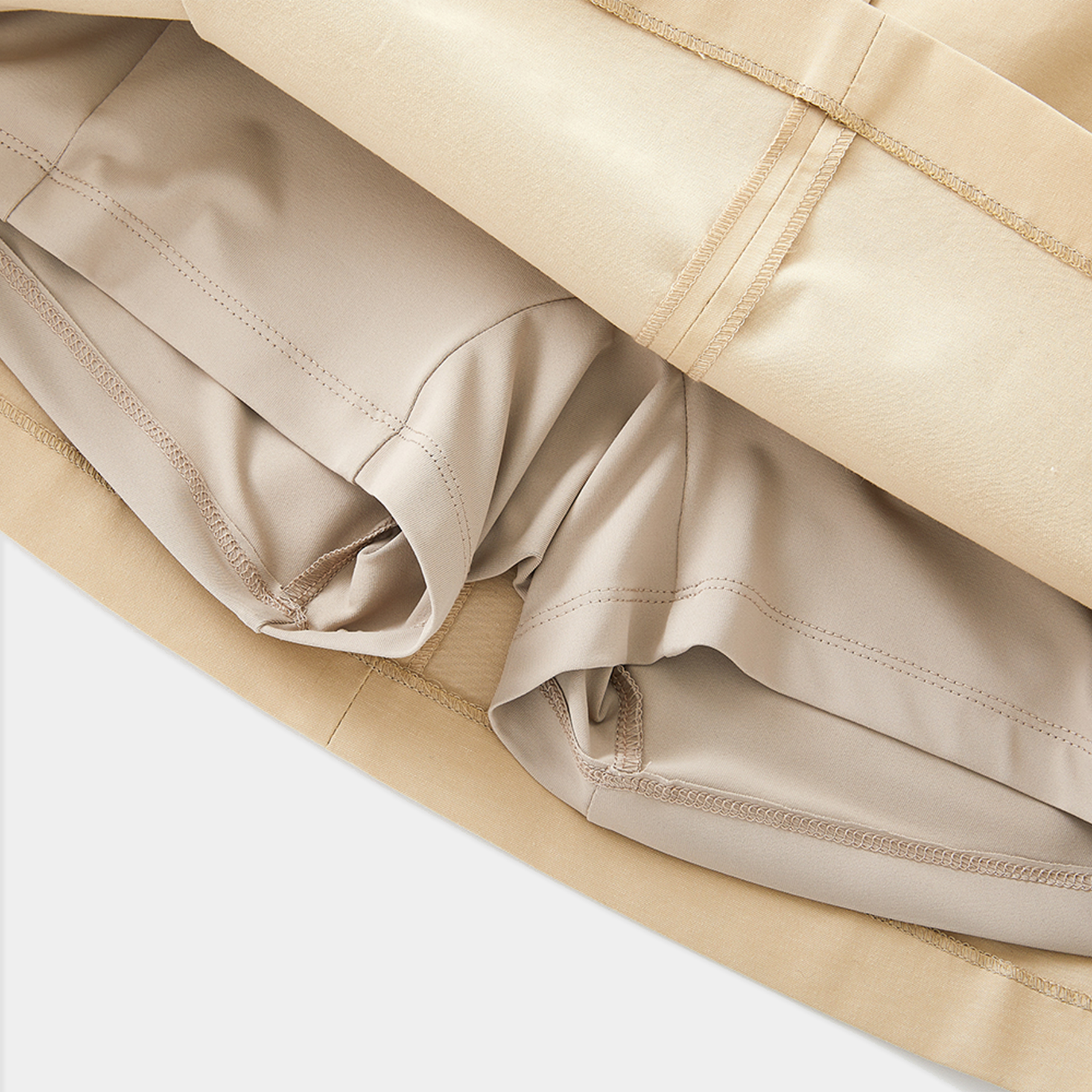 Close-up of beige skirt with a white background