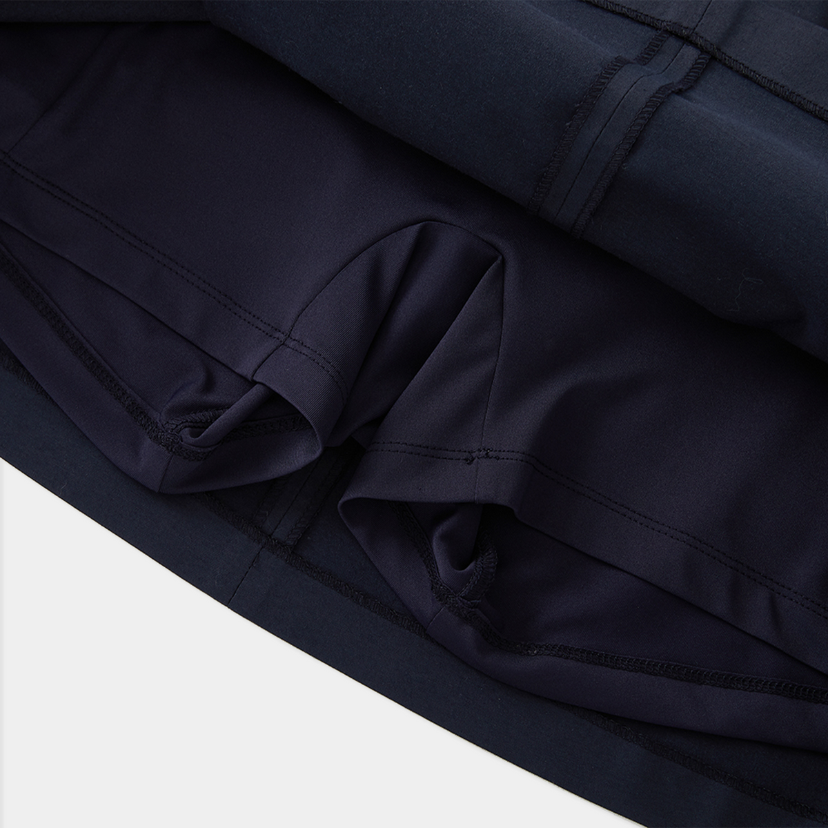 Close-up of dark blue fabric with a white background
