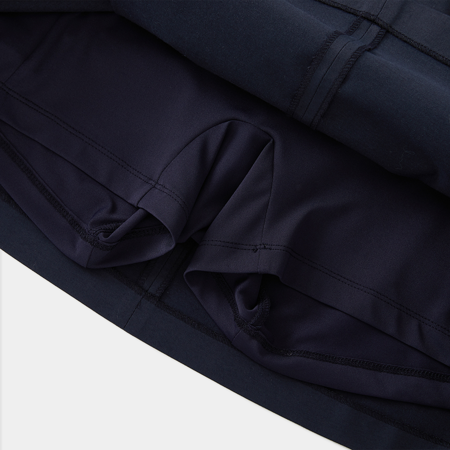 Close-up of dark blue fabric with a white background