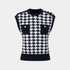 Black and white houndstooth patterned sleeveless top with button details on a light gray background