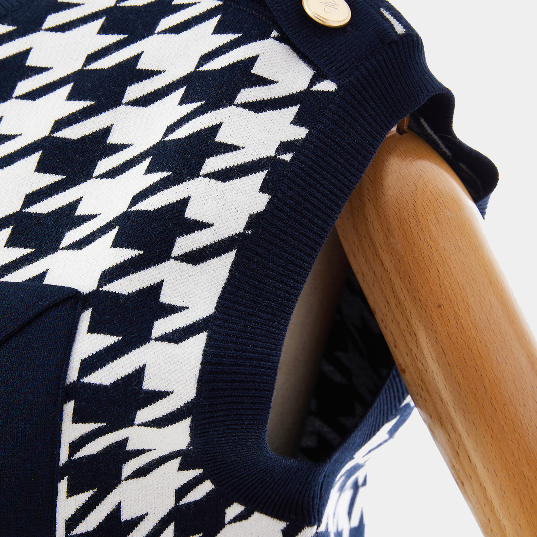 Navy and white houndstooth patterned fabric on a wooden surface