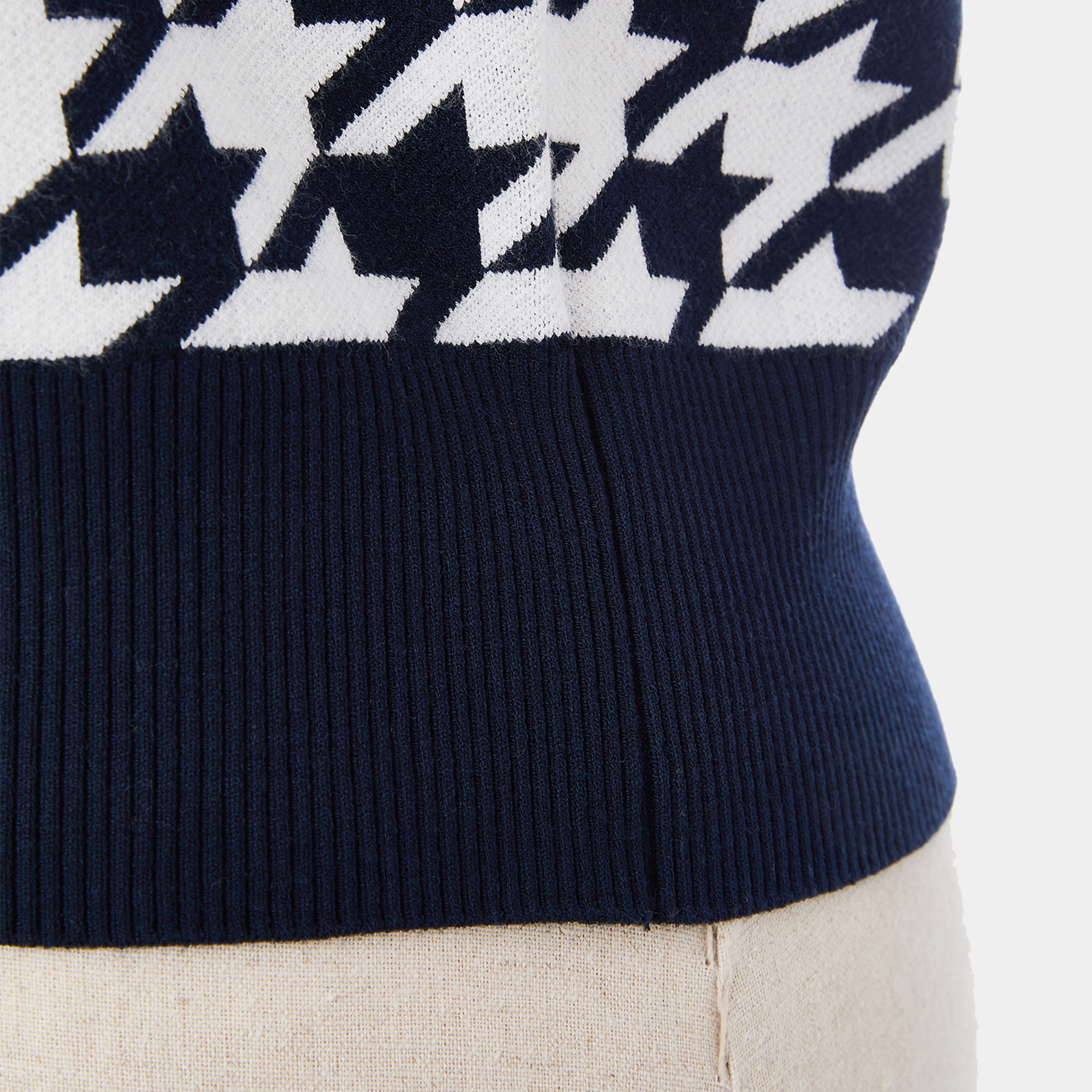 Navy sweater with white star pattern on a light background