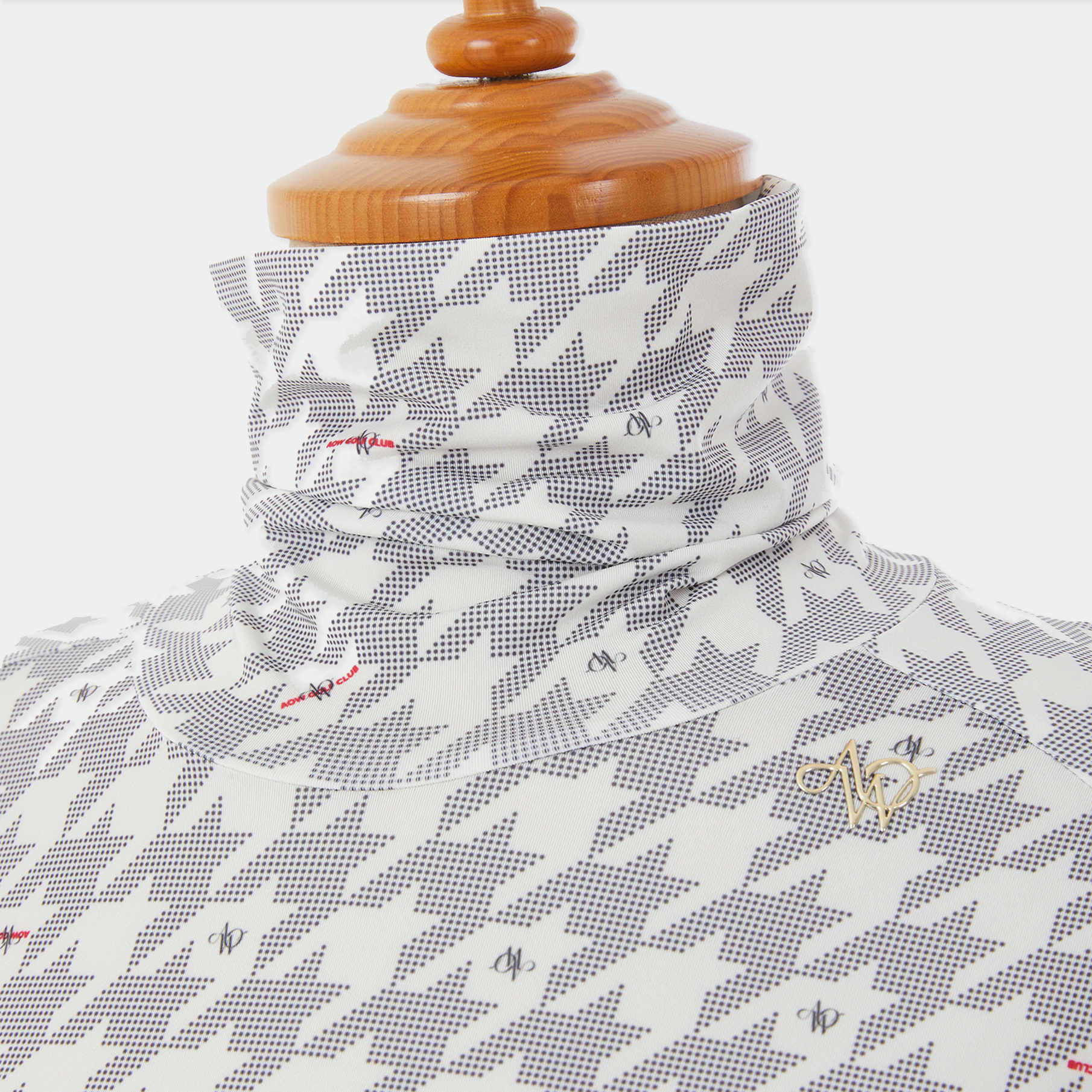 Patterned fabric on a wooden mannequin with a visible brand logo.