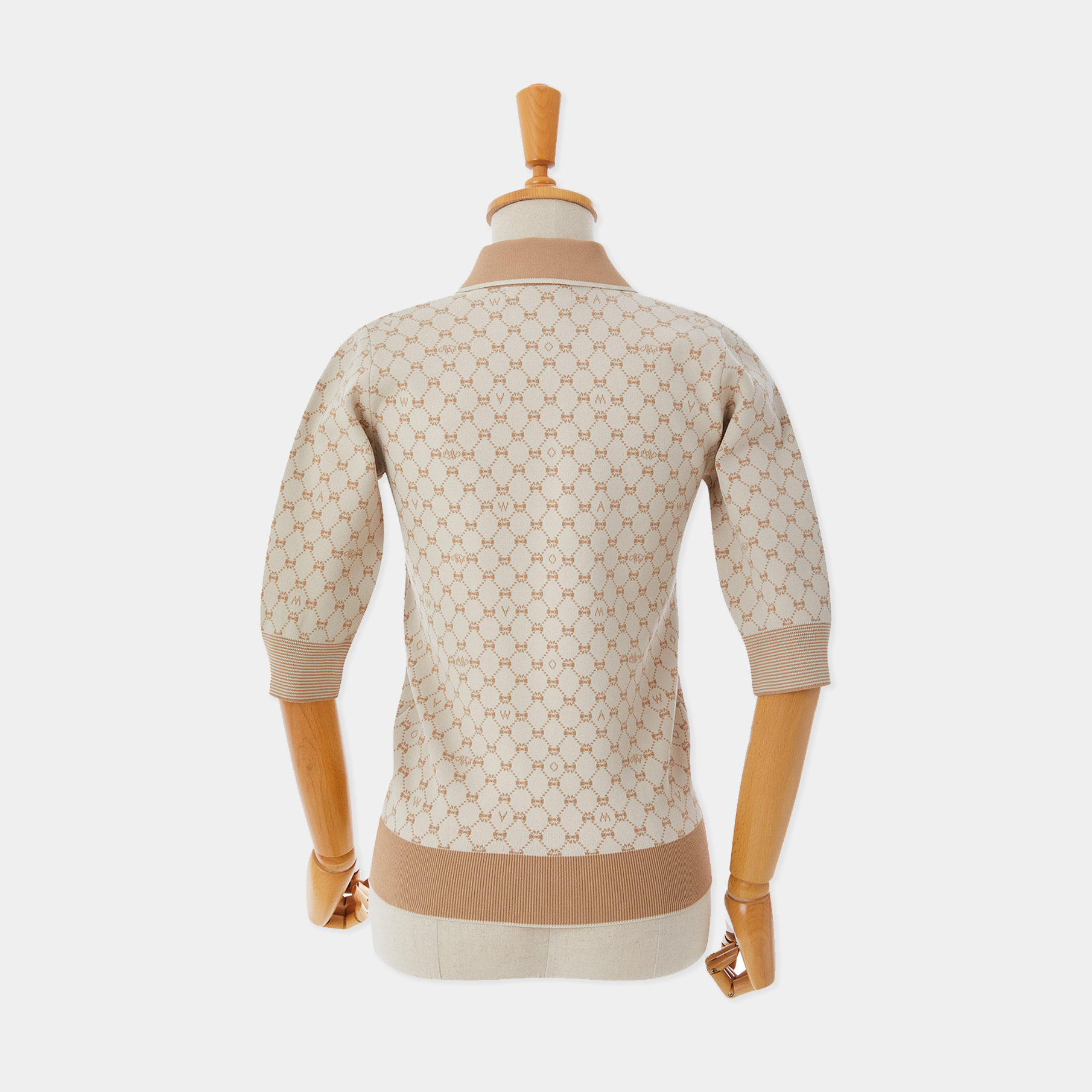 Mannequin wearing a beige patterned sweater on a white background