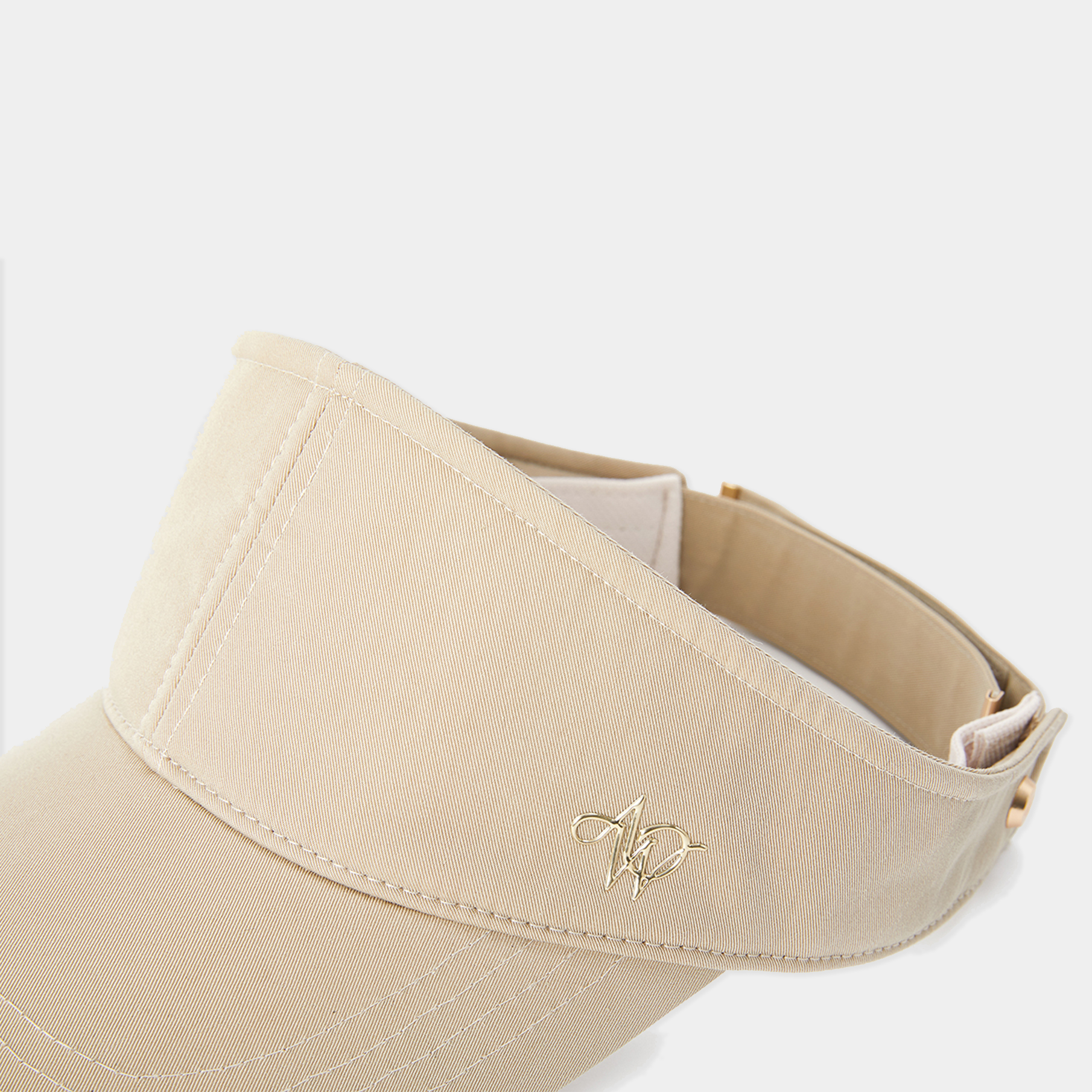 Beige visor with a logo on a white background