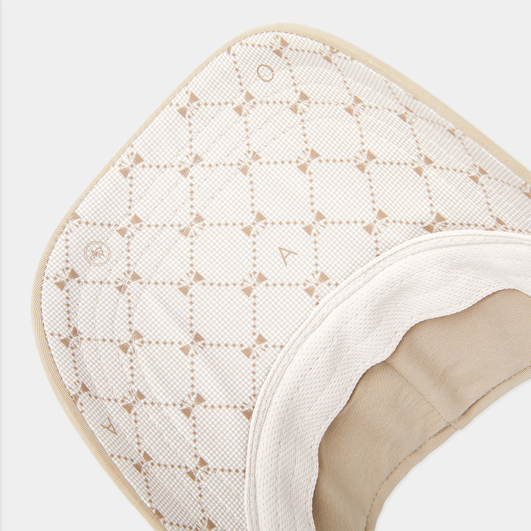 Close-up of a textured white and beige product on a light gray background