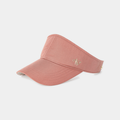 Pink visor cap with a logo on a light gray background