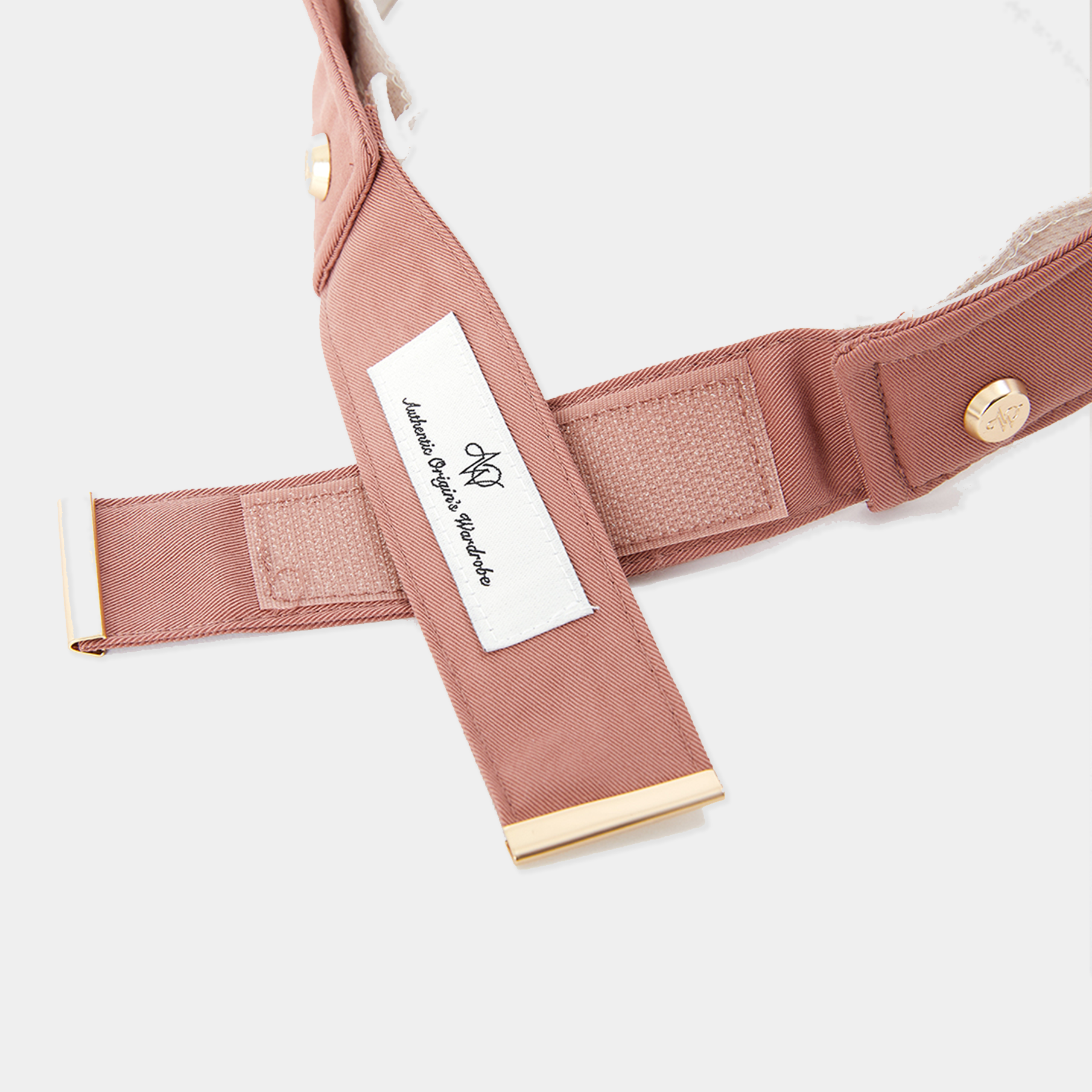 Close-up of a pink visor with a brand label on a white background