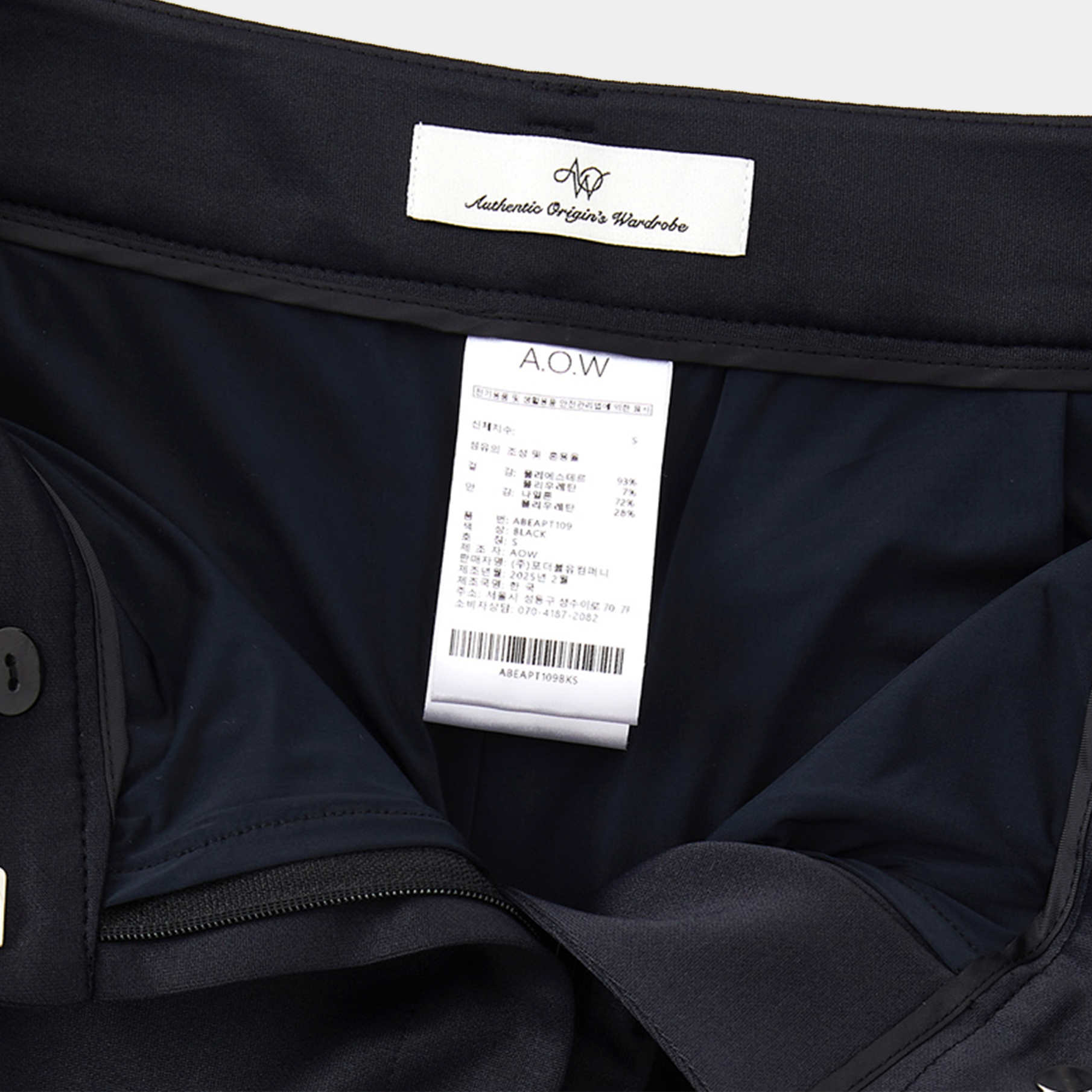 Black garment with a label and tag on a white background