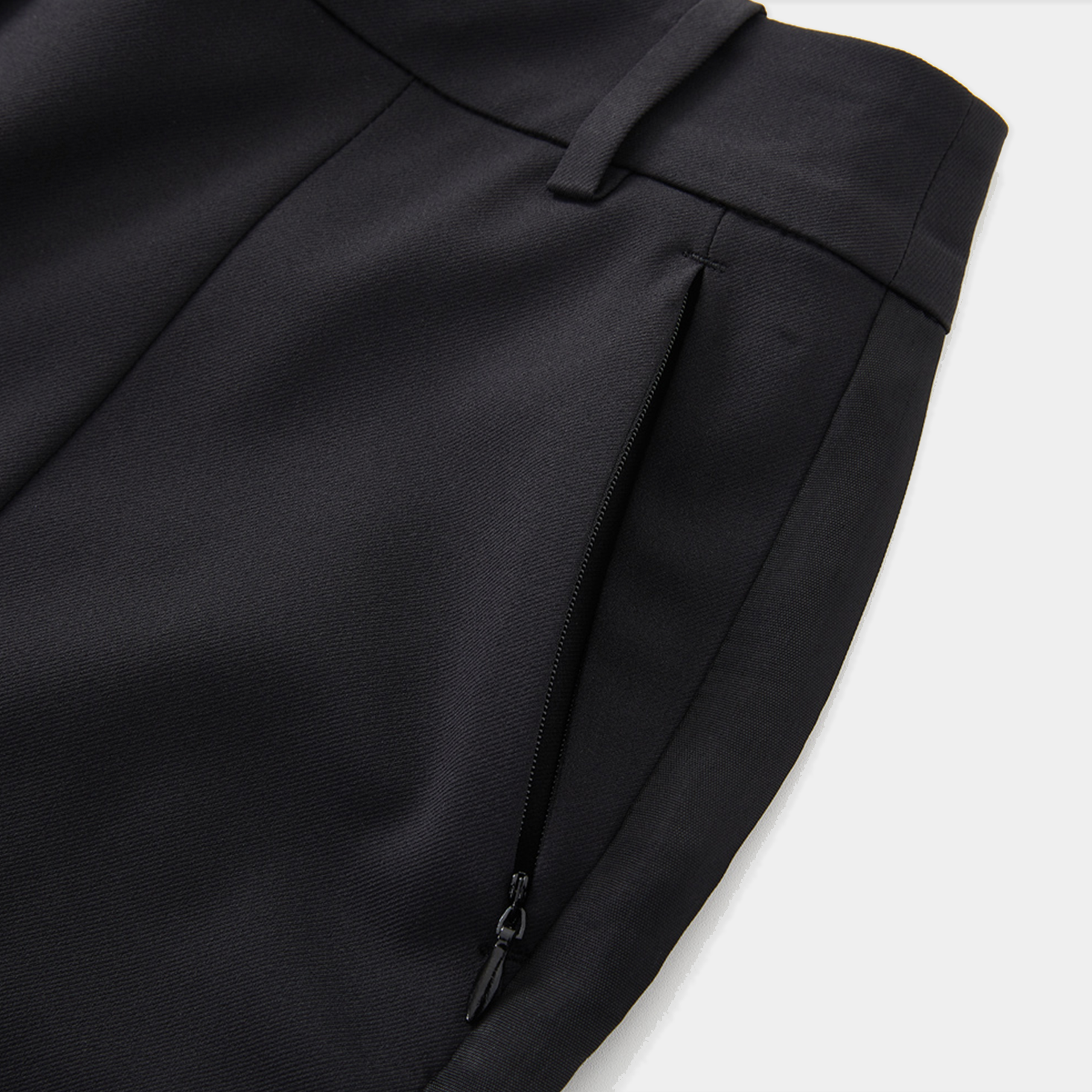 Close-up of a black suit jacket on a white background
