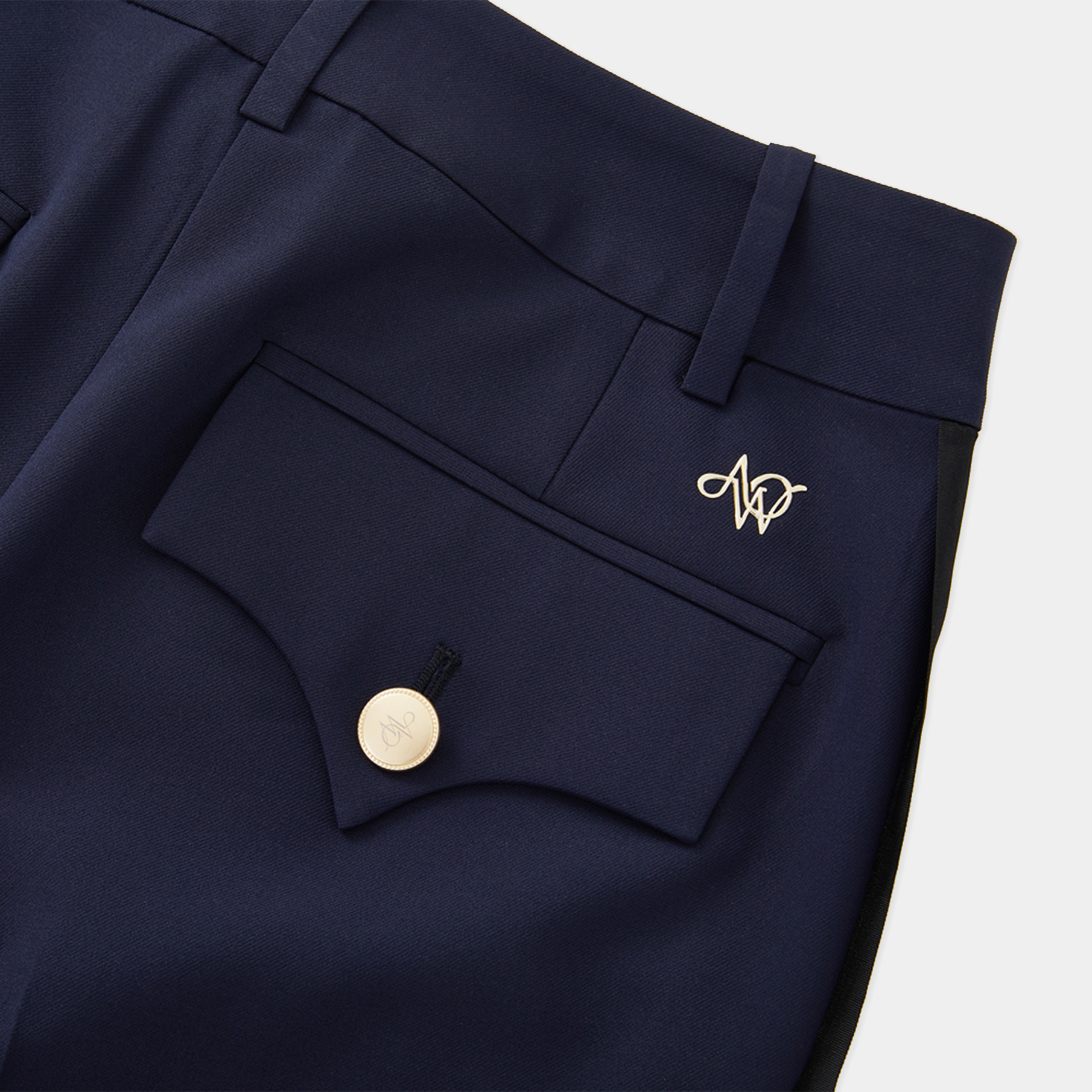 Navy blue pants with a button and logo on a white background