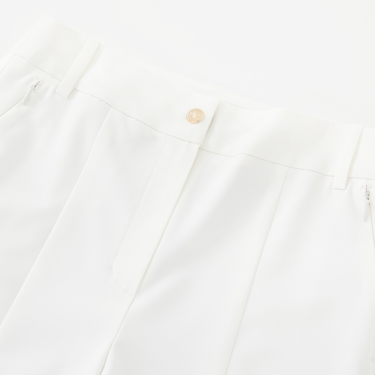 Close-up of a white pants with a button on a white background
