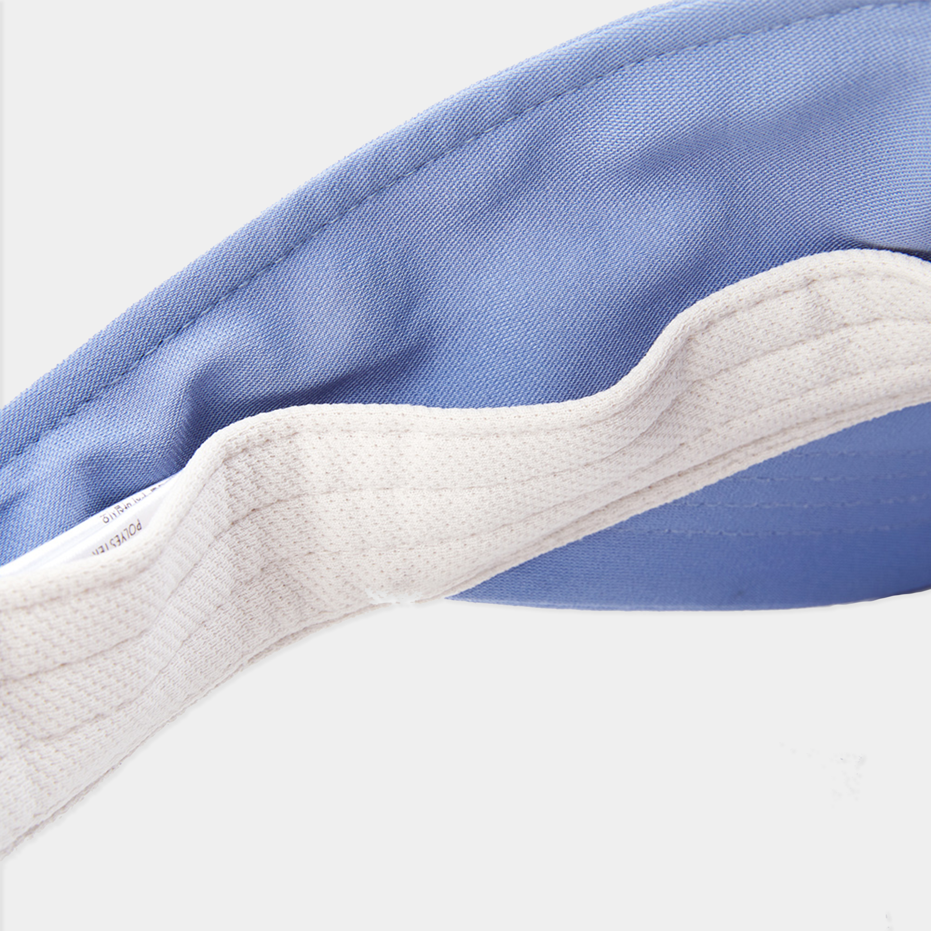 Close-up of a blue and white fabric with a visible brand label.