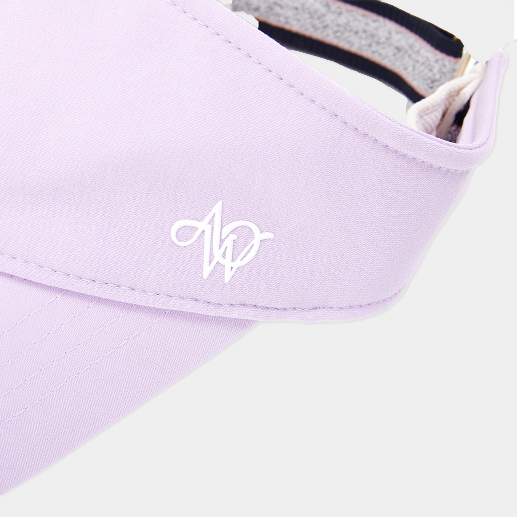 Close-up of a lilac fabric with a white logo on a light gray background