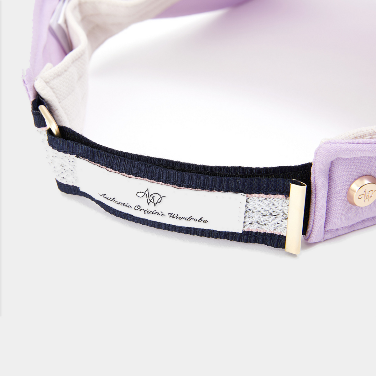 Close-up of a purple visor with a visible brand label on a white background