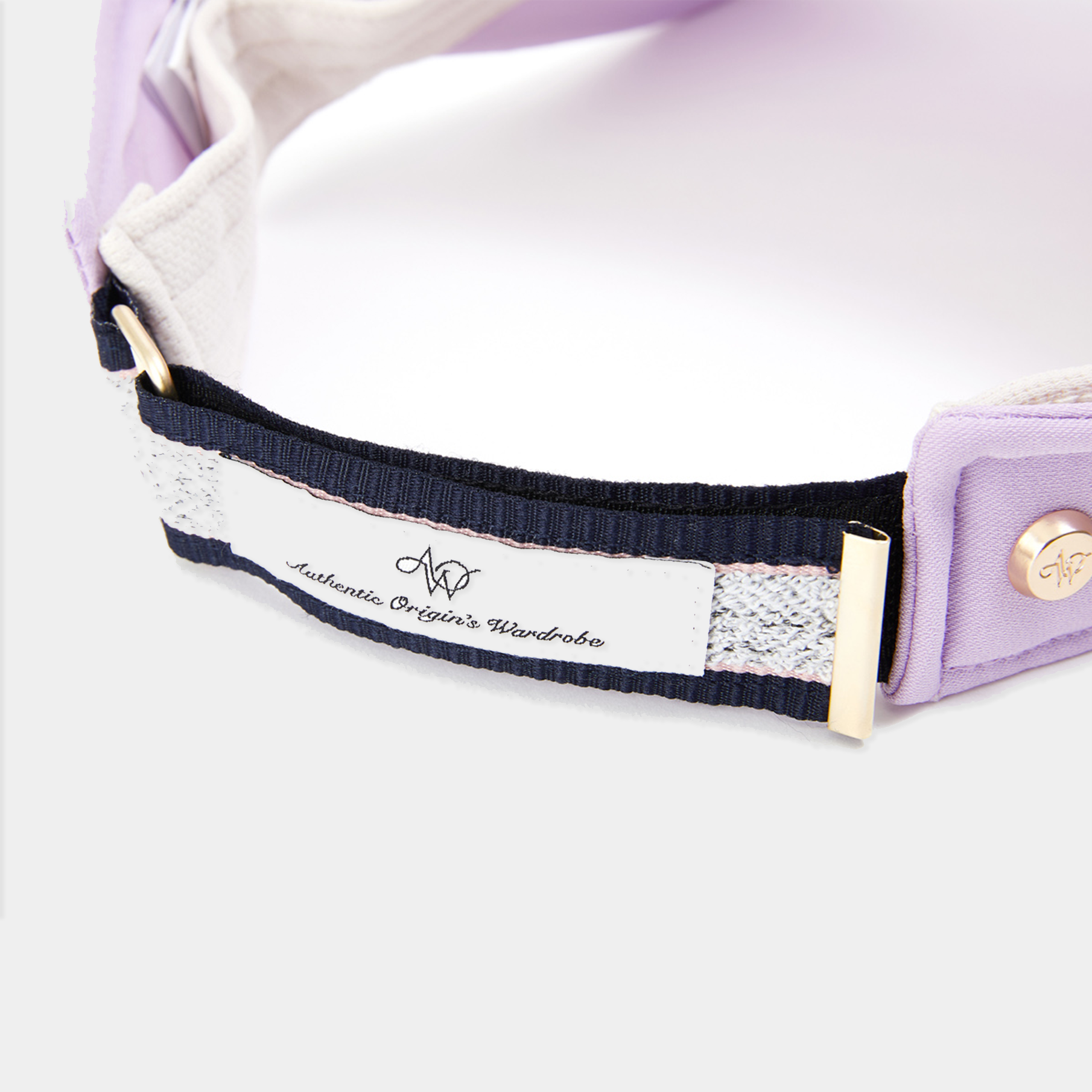 Close-up of a purple visor with a visible brand label on a white background