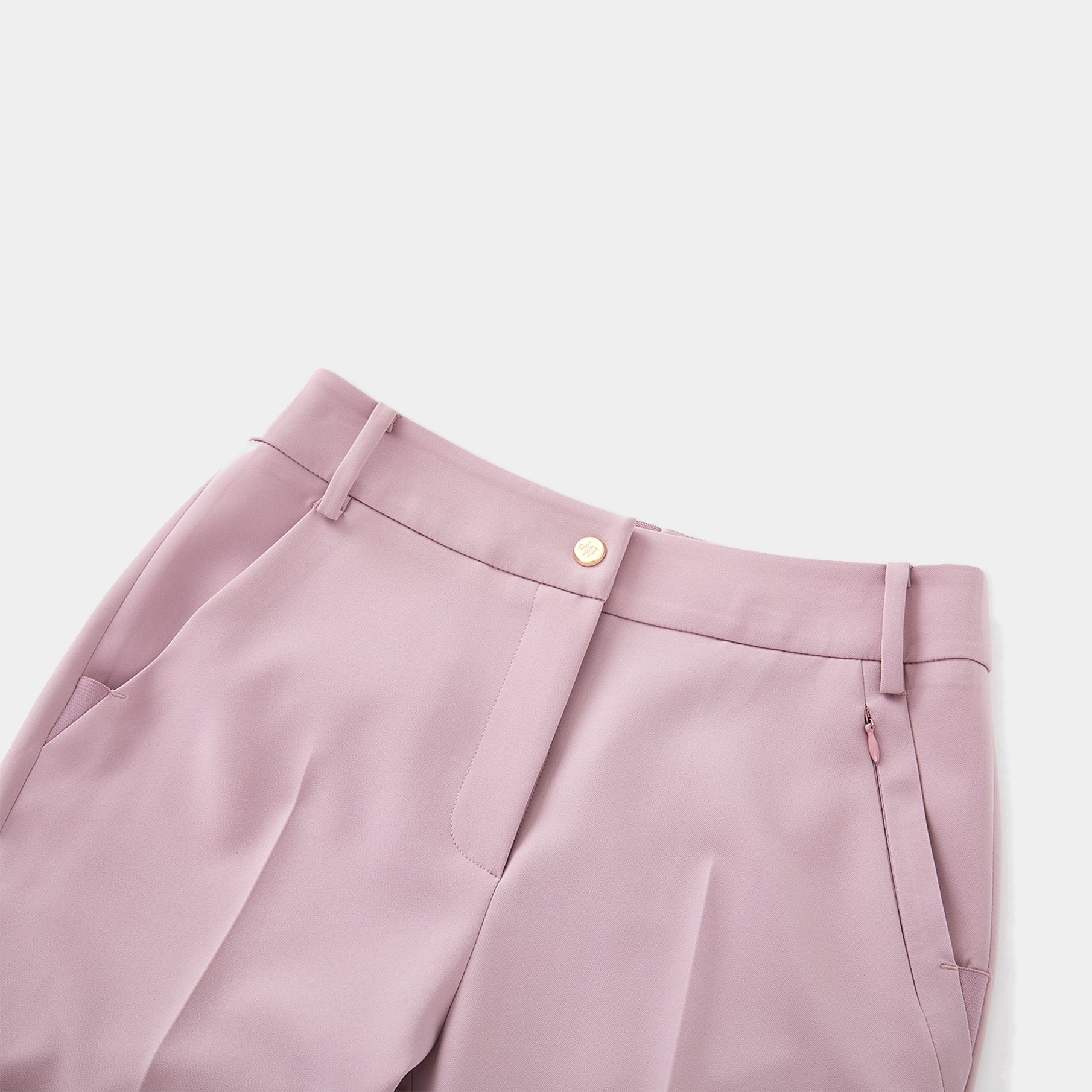 Close-up of pink pants with a button on a light gray background