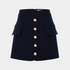 Navy blue skirt with gold buttons on a light gray background