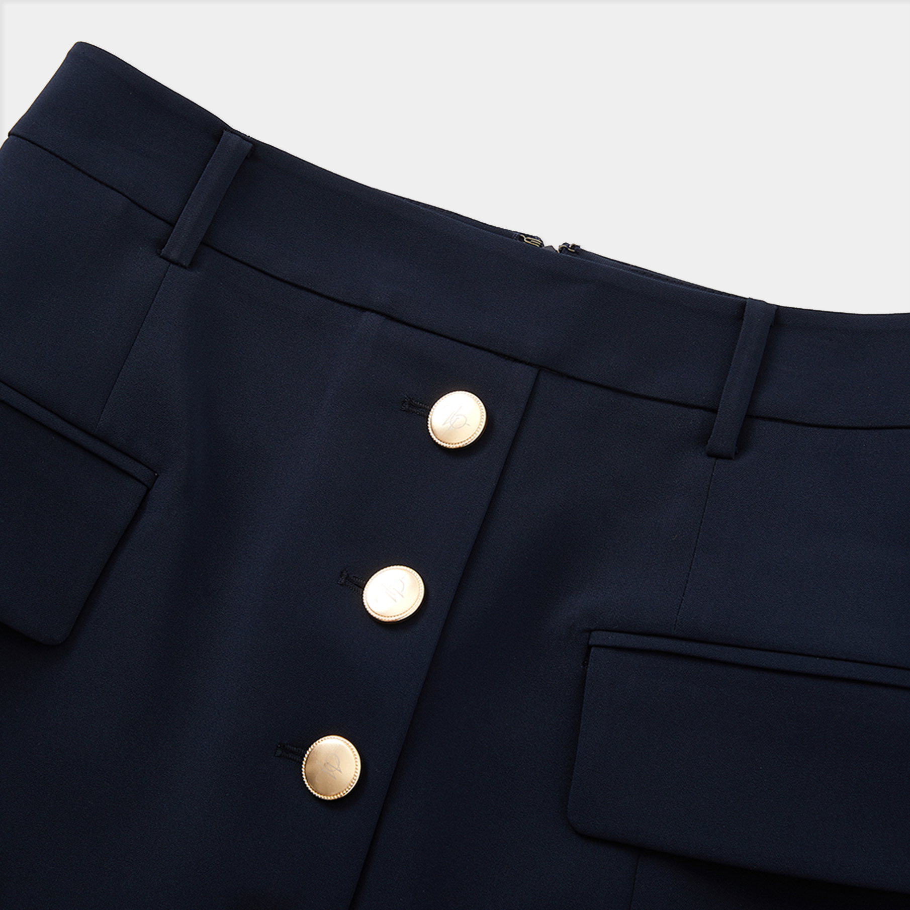 Navy blue pants with gold buttons on a white background