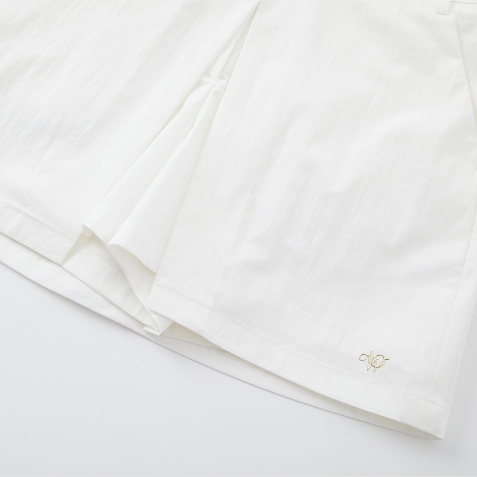 White fabric with a small logo on a white background