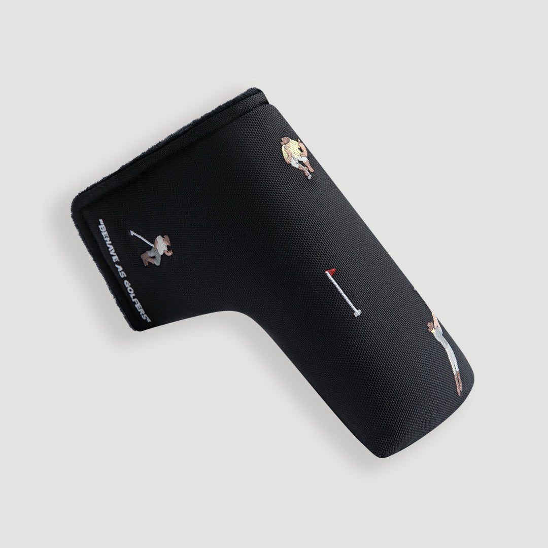 Black blade putter cover at angle showing multiple embroidered golfer figures and Behave As Golfers text - Laclavi Golf