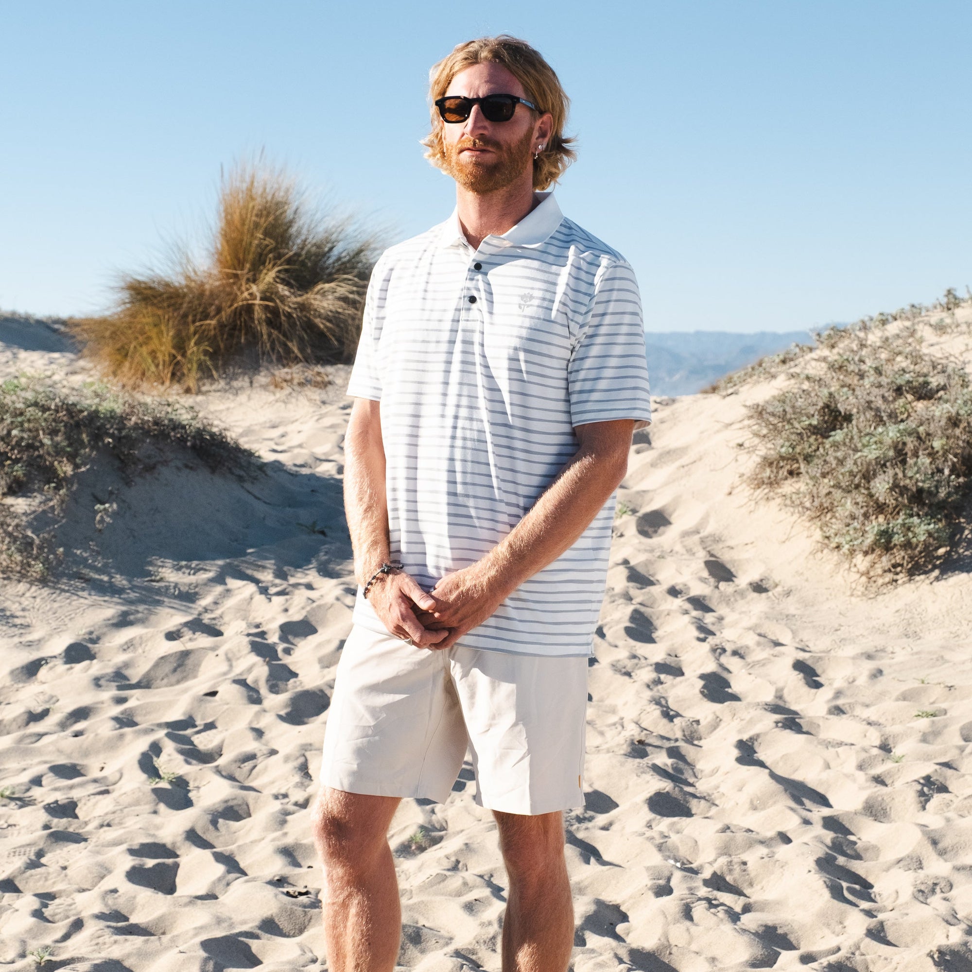 Man wearing Men's Striped Polo - White - Erthe Golf