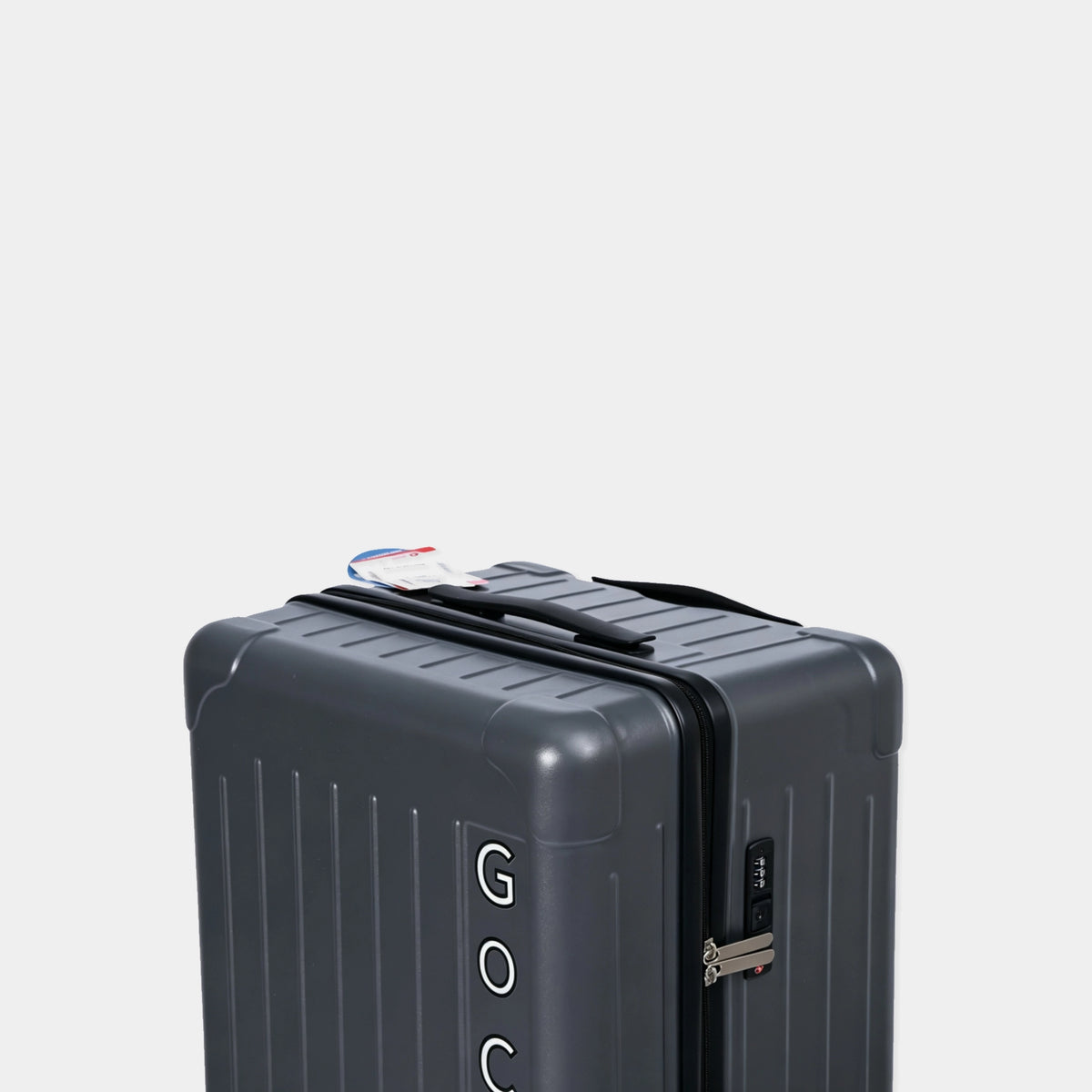 Gray suitcase with visible brand logo on a light gray background
