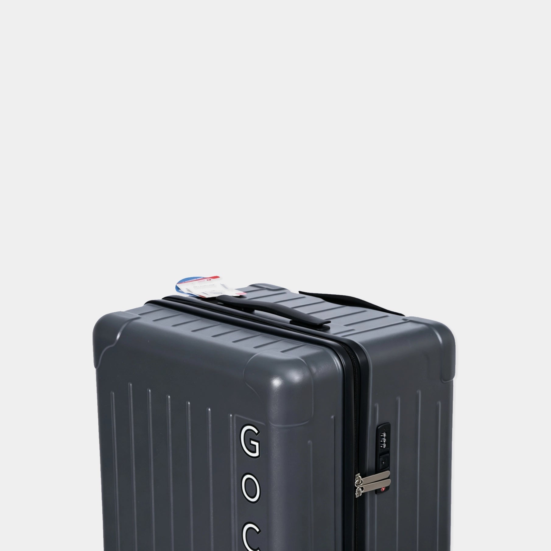 Gray suitcase with visible brand logo on a light gray background