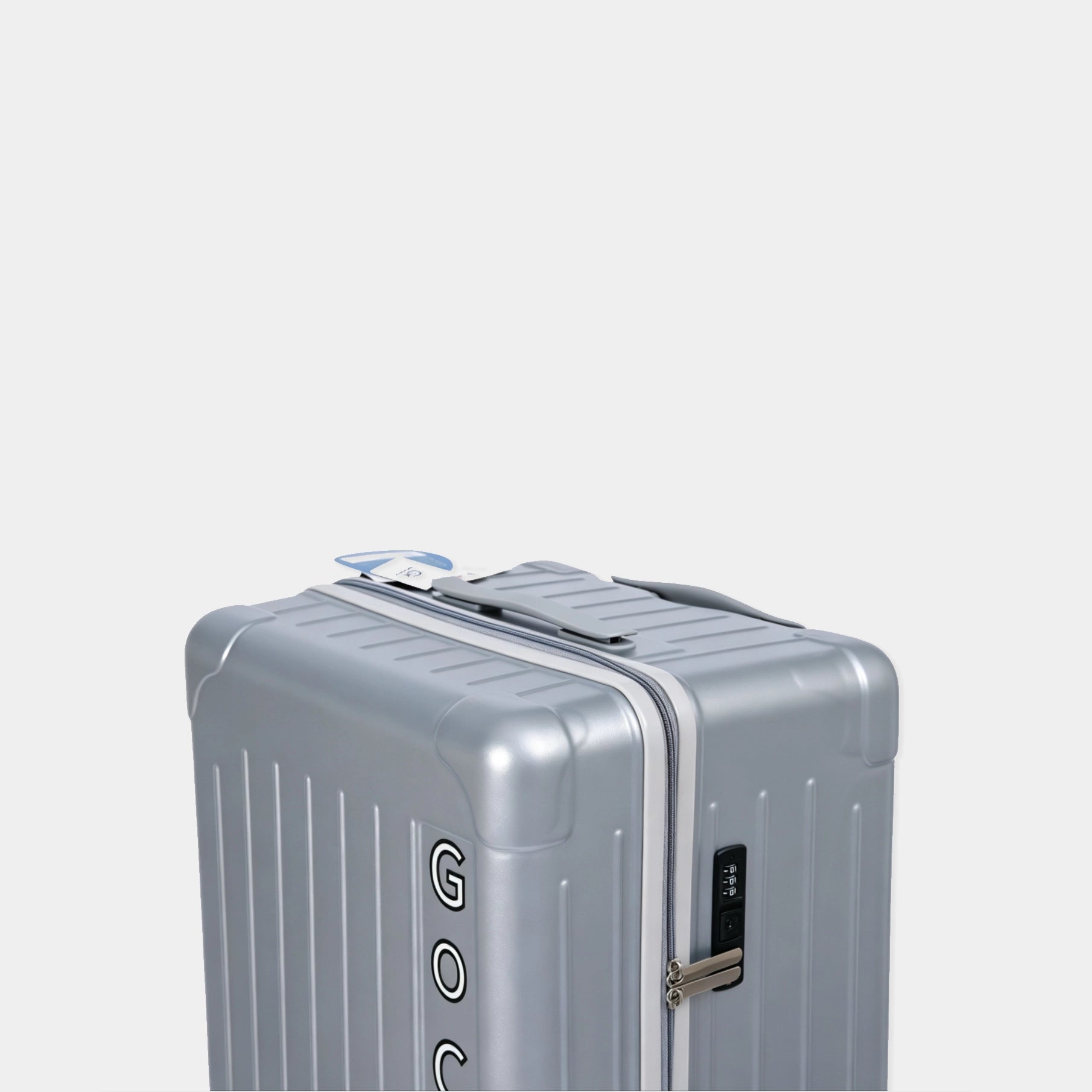 Silver travel case with a visible brand logo on a light gray background