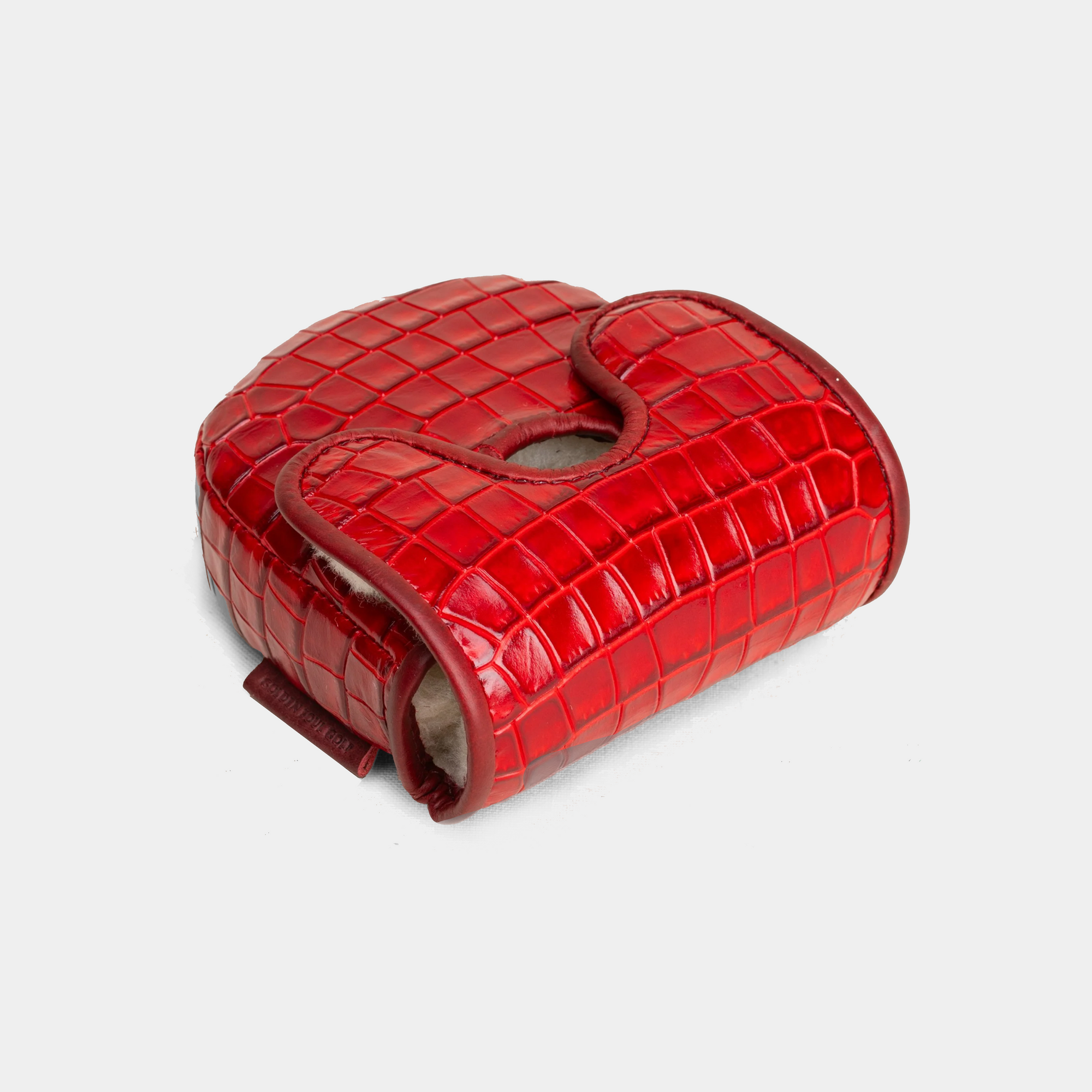 Red crocodile-patterned d3 putter cover on a light gray background - side view