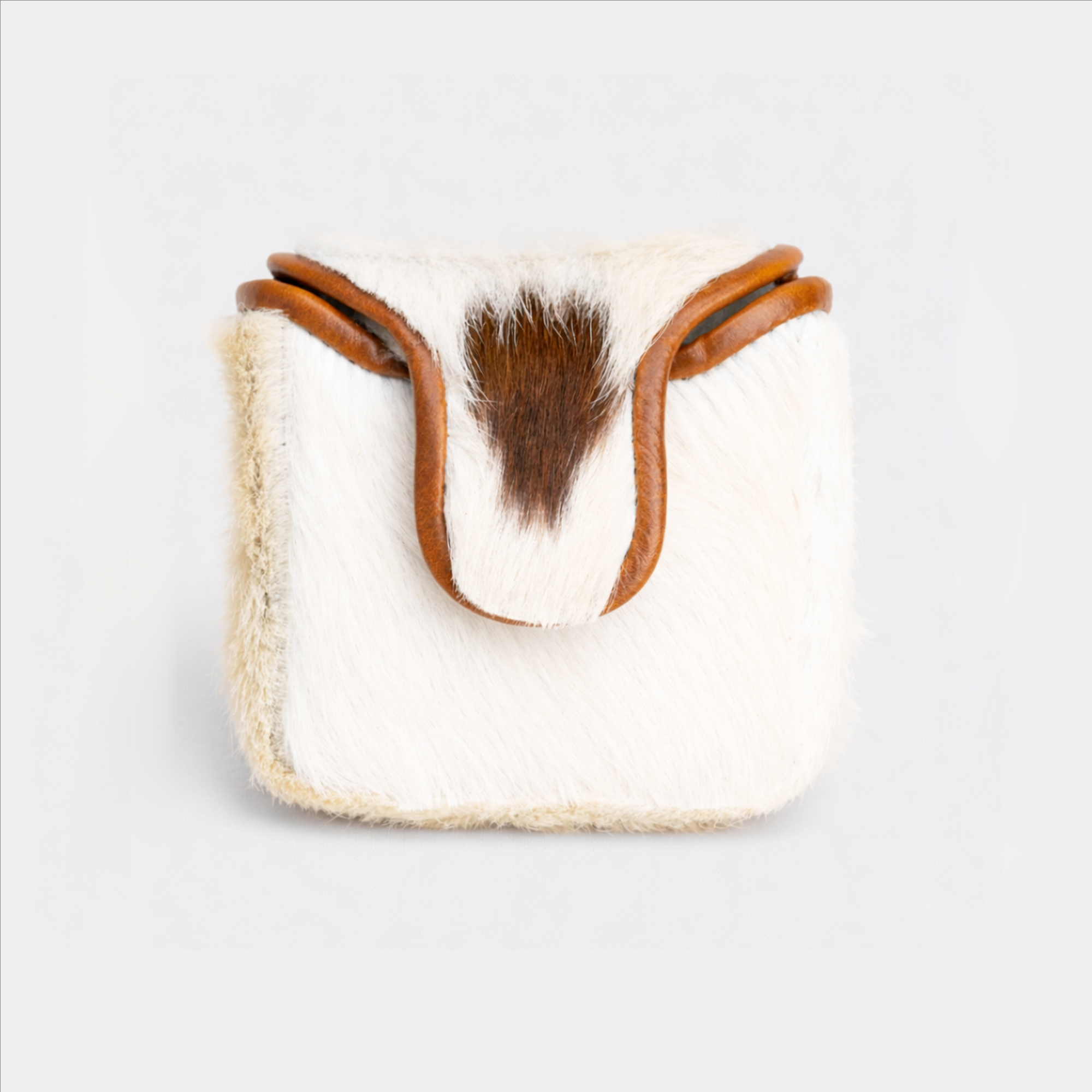 White mallet putter cover with brown leather strap on a light gray background