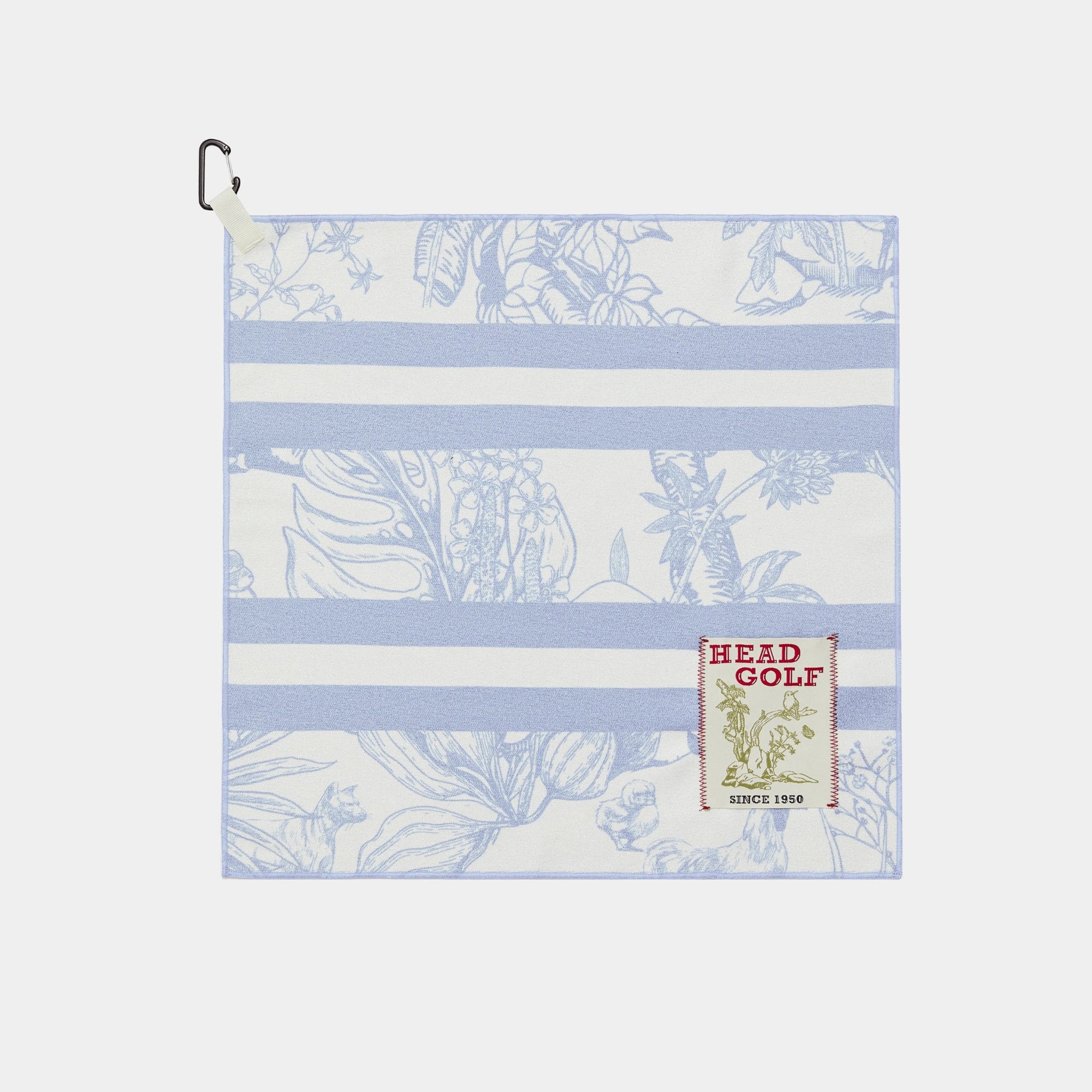 A square golf towel with a light blue and white striped pattern, featuring a botanical print and a 'HEAD GOLF' brand patch on the lower right, complete with a black carabiner clip on the top left.