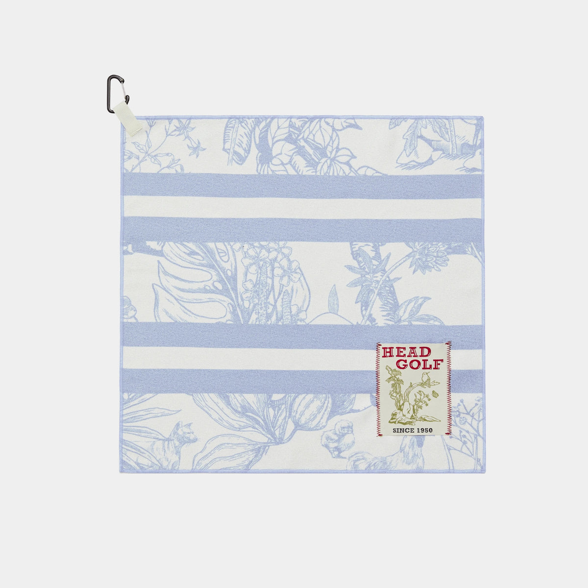 A square golf towel with a light blue and white striped pattern, featuring a botanical print and a 'HEAD GOLF' brand patch on the lower right, complete with a black carabiner clip on the top left.