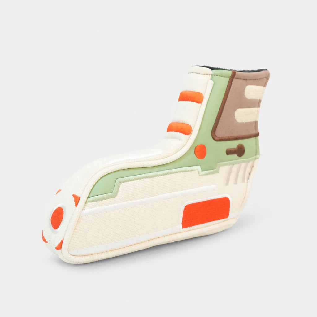 A novelty blade putter cover with a retro sci-fi design, featuring cream, sage green, orange, and brown panels on a light gray background.