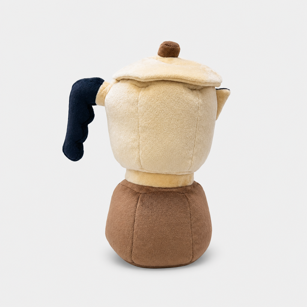 A plush coffee pot wood cover shaped like a moka pot, featuring a cream-colored body, brown base, dark navy blue handle, and a small brown knob on the lid, shown against a light gray background.