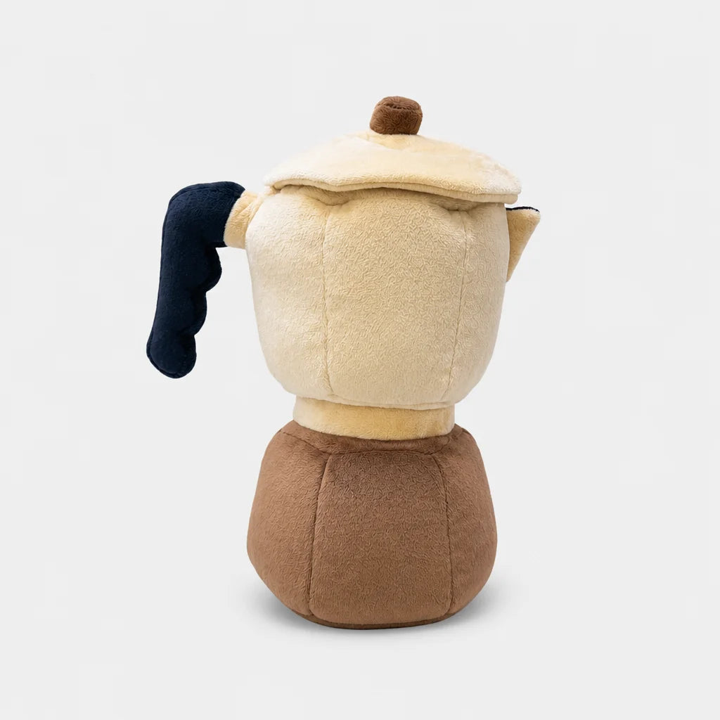 A plush coffee pot wood cover shaped like a moka pot, featuring a cream-colored body, brown base, dark navy blue handle, and a small brown knob on the lid, shown against a light gray background.