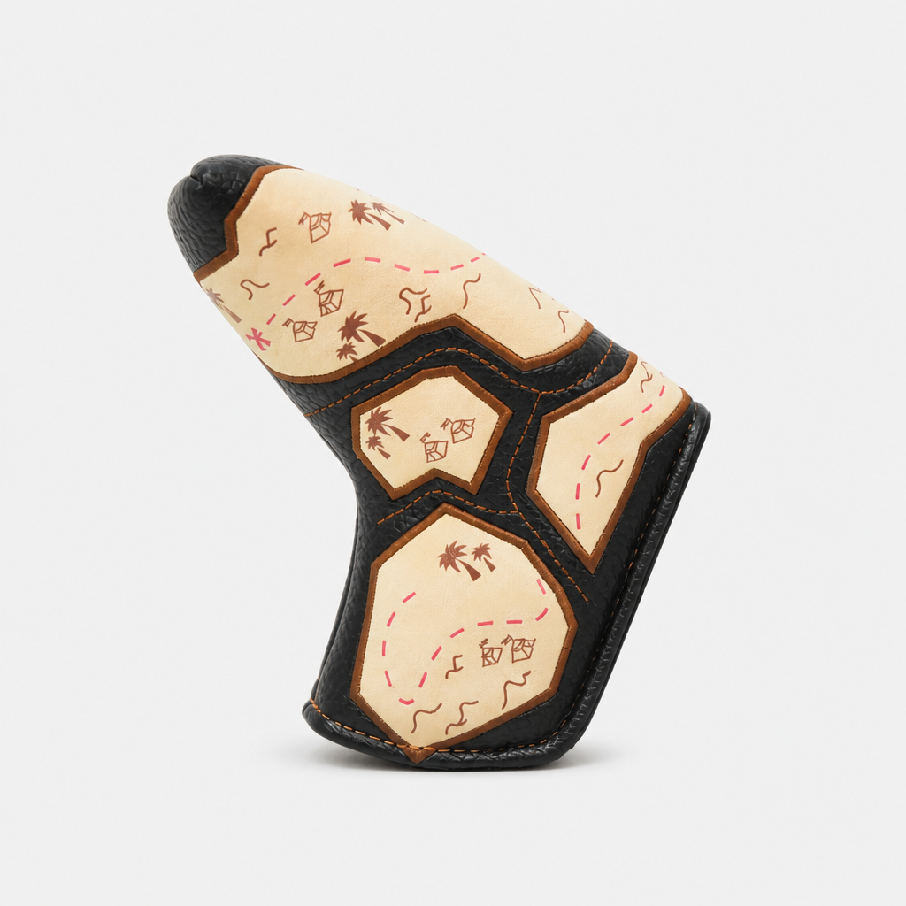 A golf club headcover with a Native American-inspired map design, featuring cream panels with brown and red illustrations of a compass, stars, and palm trees, bordered by black leather-like trim, shown on a light gray background.