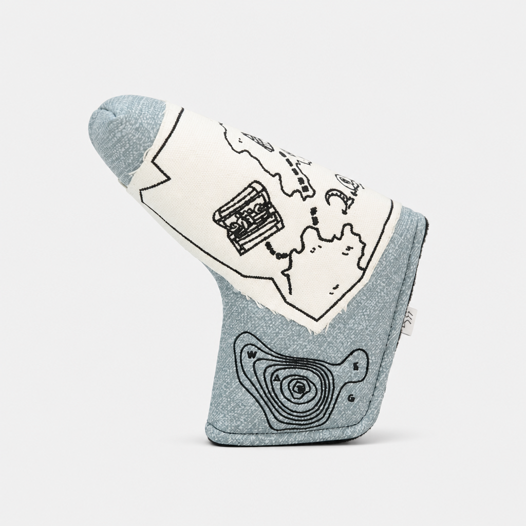 A golf tees headcover made of heathered light blue fabric with black line-art illustrations of a map, a pocket watch, and topographic lines, shown on a light gray background.