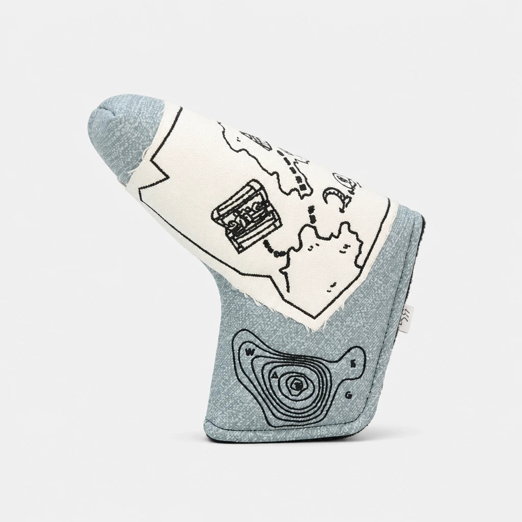 A golf tees headcover made of heathered light blue fabric with black line-art illustrations of a map, a pocket watch, and topographic lines, shown on a light gray background.
