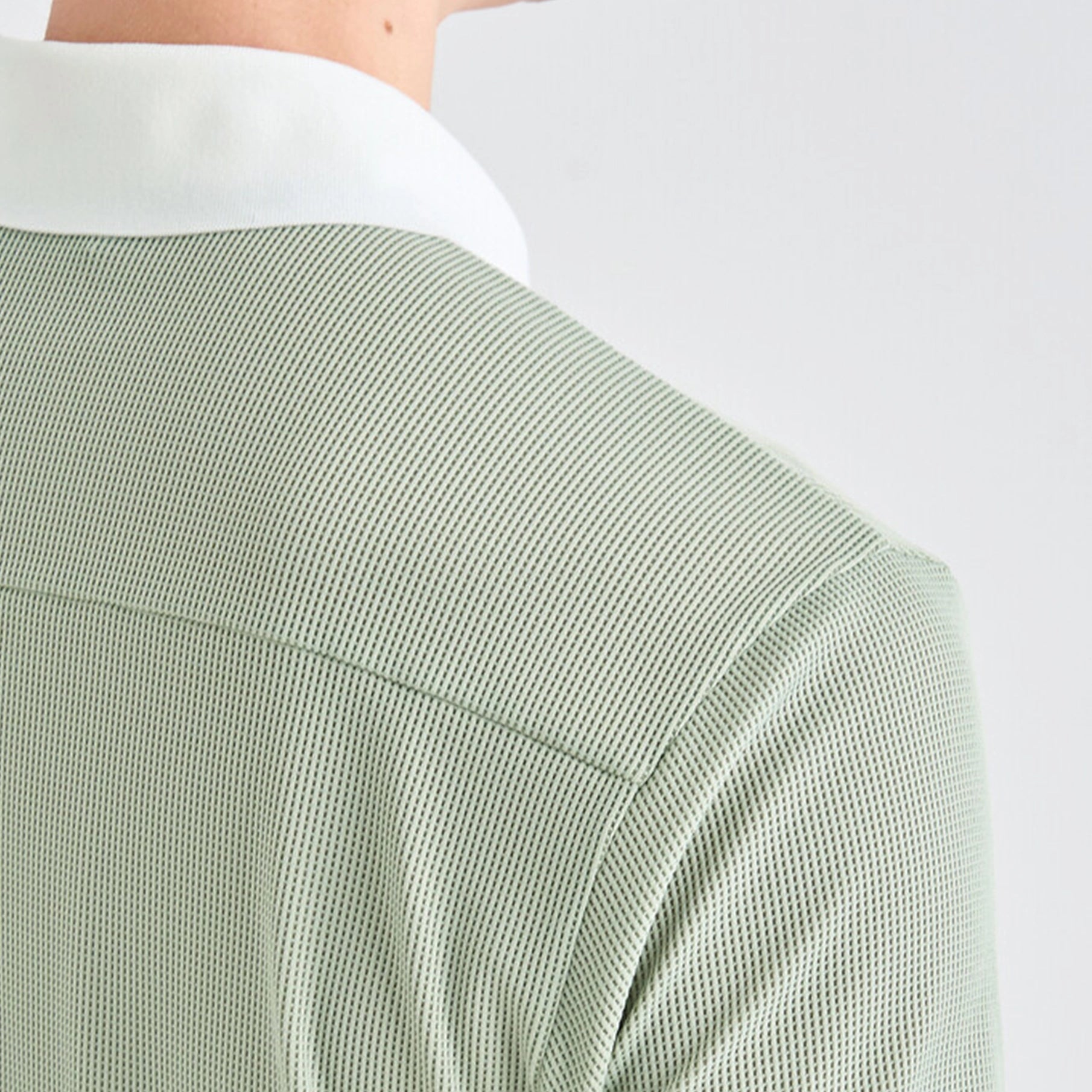 Green textured shirt sleeve on a white background