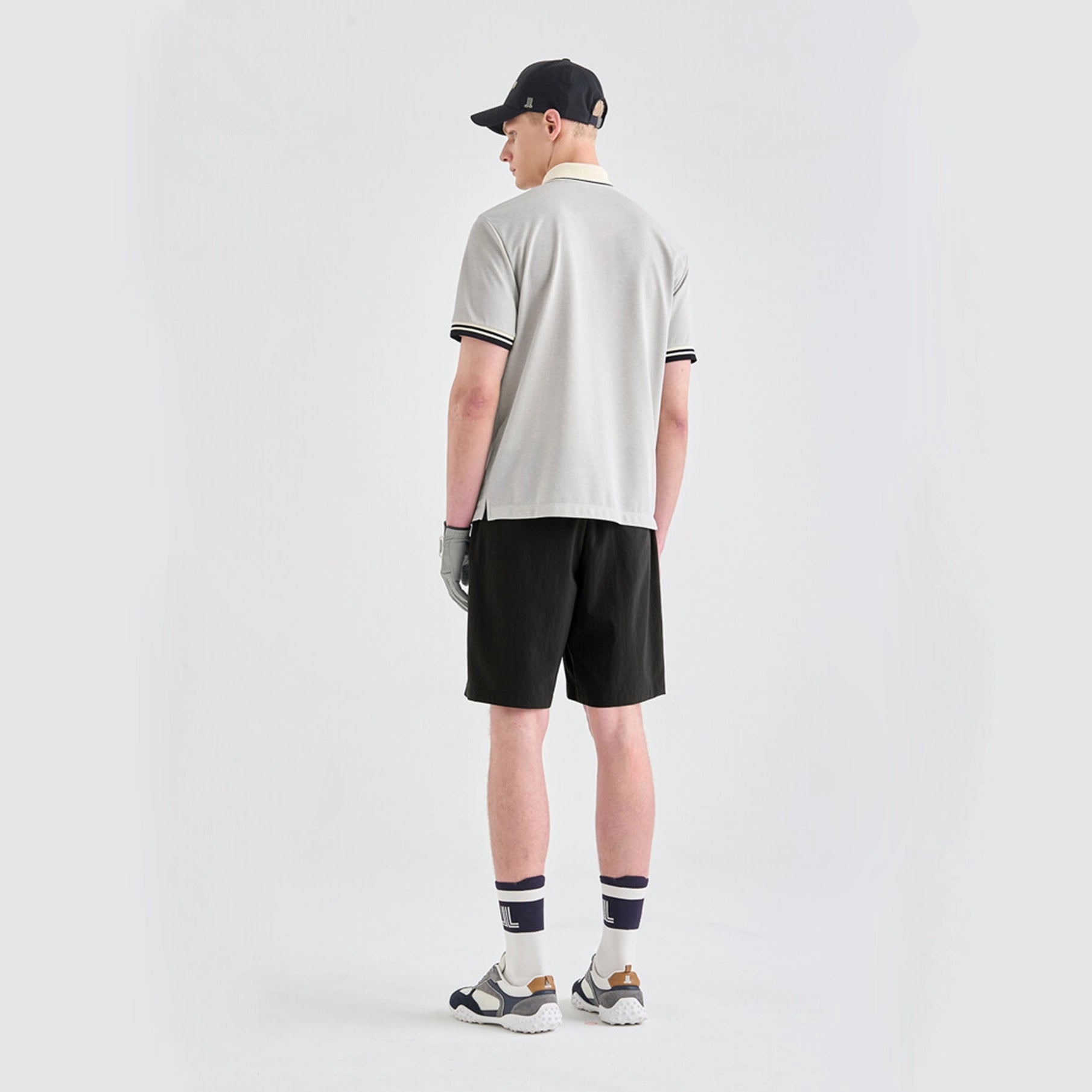 Man wearing a grey polo shirt on a white background