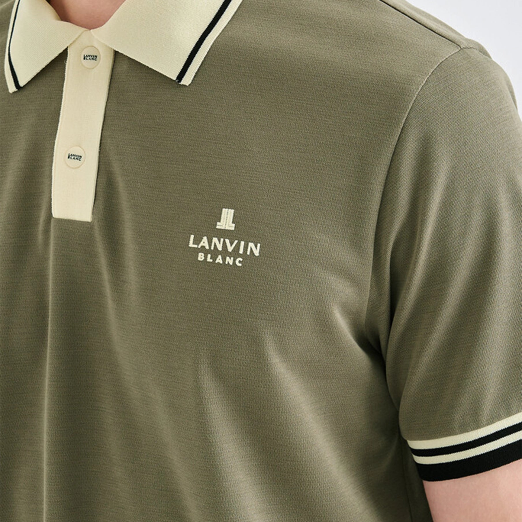 Green polo shirt with 'Lanvin Blanc' logo on a person wearing it.