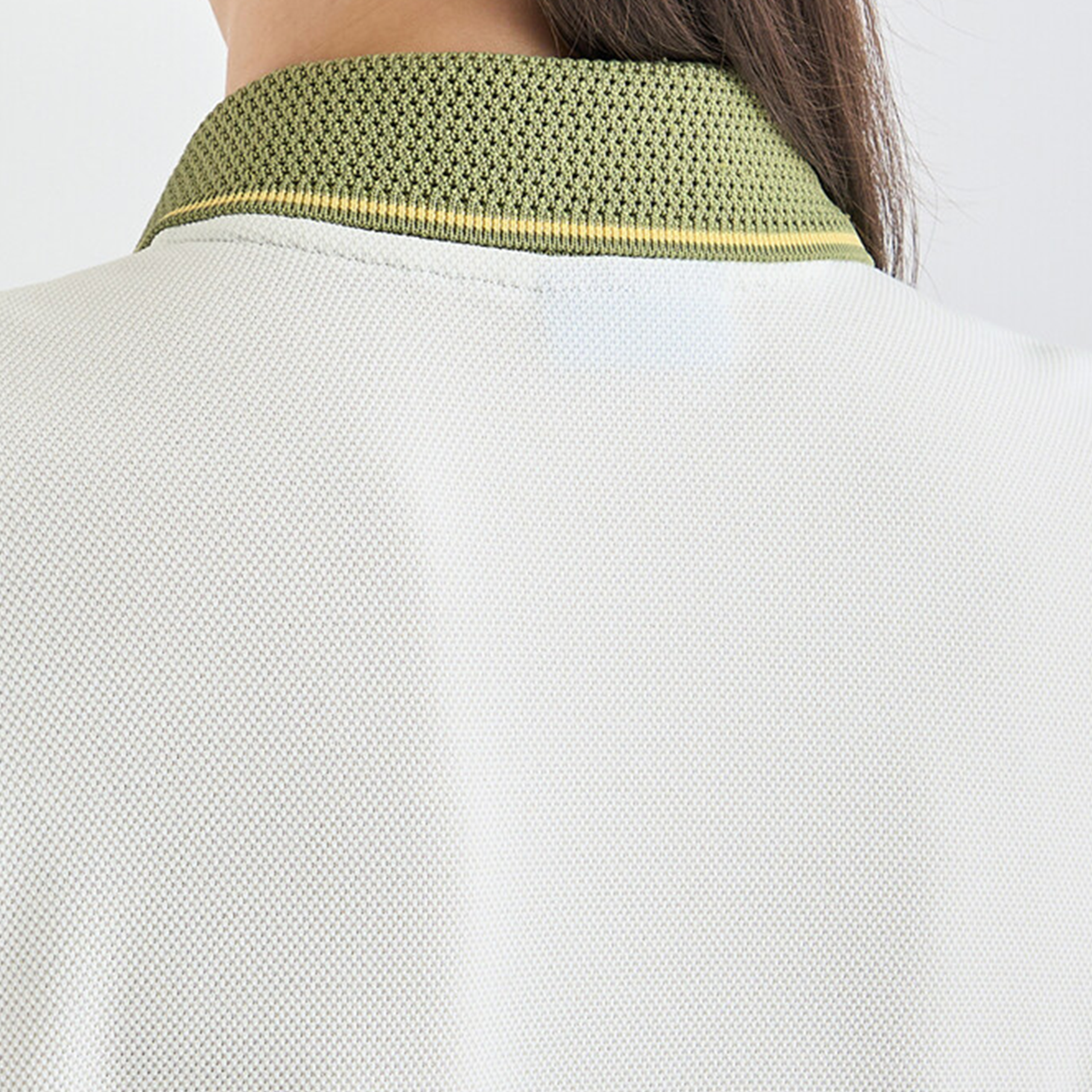 Close-up of a textured green collar on a light gray background