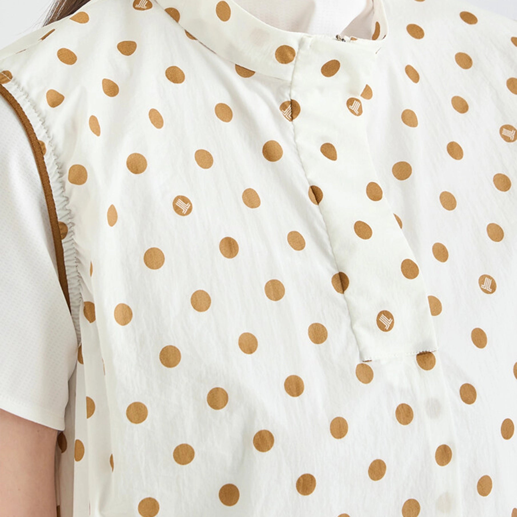 Close-up of a white shirt with brown polka dots