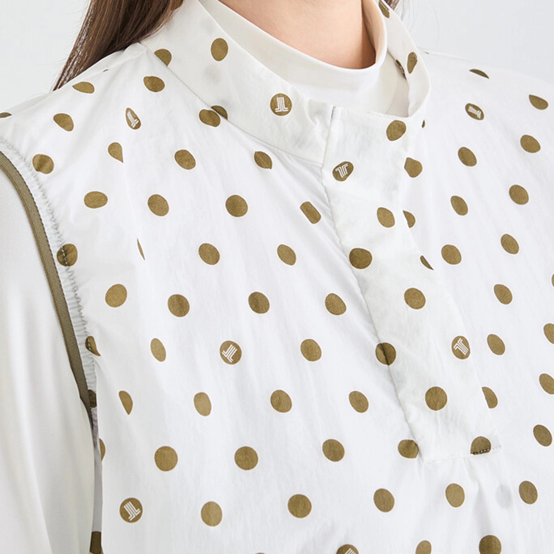 White garment with gold polka dots worn by a person